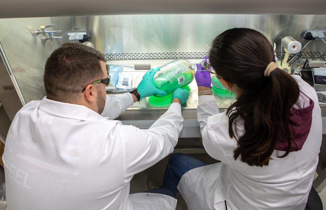 Kennedy Space Center’s Brint Bauer, left, and Carolina Franco, Ph.D., collect samples from a water tank, filled with green dye, for a biological study in the Florida spaceport’s Neil Armstrong Operations and Checkout Building on Nov. 13, 2019. Two tanks have recently returned to Kennedy after spending the last five years on the International Space Station for an experiment to study slosh, or the movement of water, in a zero-gravity environment to help engineers predict the movement of propellant in rocket tanks. Kennedy’s Air and Water Revitalization lab is studying the water tanks to determine if there is, or was, any microbial growth within them. The results will help NASA determine whether clean water can be stored in space for long-duration missions, an essential component to keeping astronauts safe and healthy as the agency prepares for missions to the Moon and beyond to Mars. 