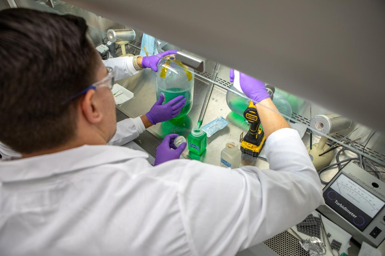 A Kennedy Space Center employee collects samples from a water tank, filled with green dye, for a biological study in the Florida spaceport’s Neil Armstrong Operations and Checkout Building on Nov. 13, 2019. Two tanks have recently returned to Kennedy after spending the last five years on the International Space Station for an experiment to study slosh, or the movement of water, in a zero-gravity environment to help engineers predict the movement of propellant in rocket tanks. With the slosh experiment now concluded, the tanks are being utilized to determine if there is, or was, any microbial growth within them. The results will help NASA determine whether clean water can be stored in space for long-duration missions, an essential component to keeping astronauts safe and healthy as the agency prepares for missions to the Moon and beyond to Mars. 