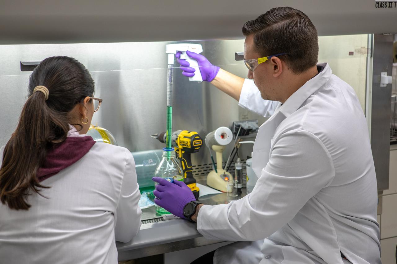 Kennedy Space Center’s Carolina Franco, Ph.D., left, and Jason Fischer collect samples from a water tank, filled with green dye, for a biological study in the Florida spaceport’s Neil Armstrong Operations and Checkout Building on Nov. 13, 2019. Two tanks have recently returned to Kennedy after spending the last five years on the International Space Station for an experiment to study slosh, or the movement of water, in a zero-gravity environment to help engineers predict the movement of propellant in rocket tanks. Kennedy’s Air and Water Revitalization lab is studying the water tanks to determine if there is, or was, any microbial growth within them. The results will help NASA determine whether clean water can be stored in space for long-duration missions, an essential component to keeping astronauts safe and healthy as the agency prepares for missions to the Moon and beyond to Mars. 
