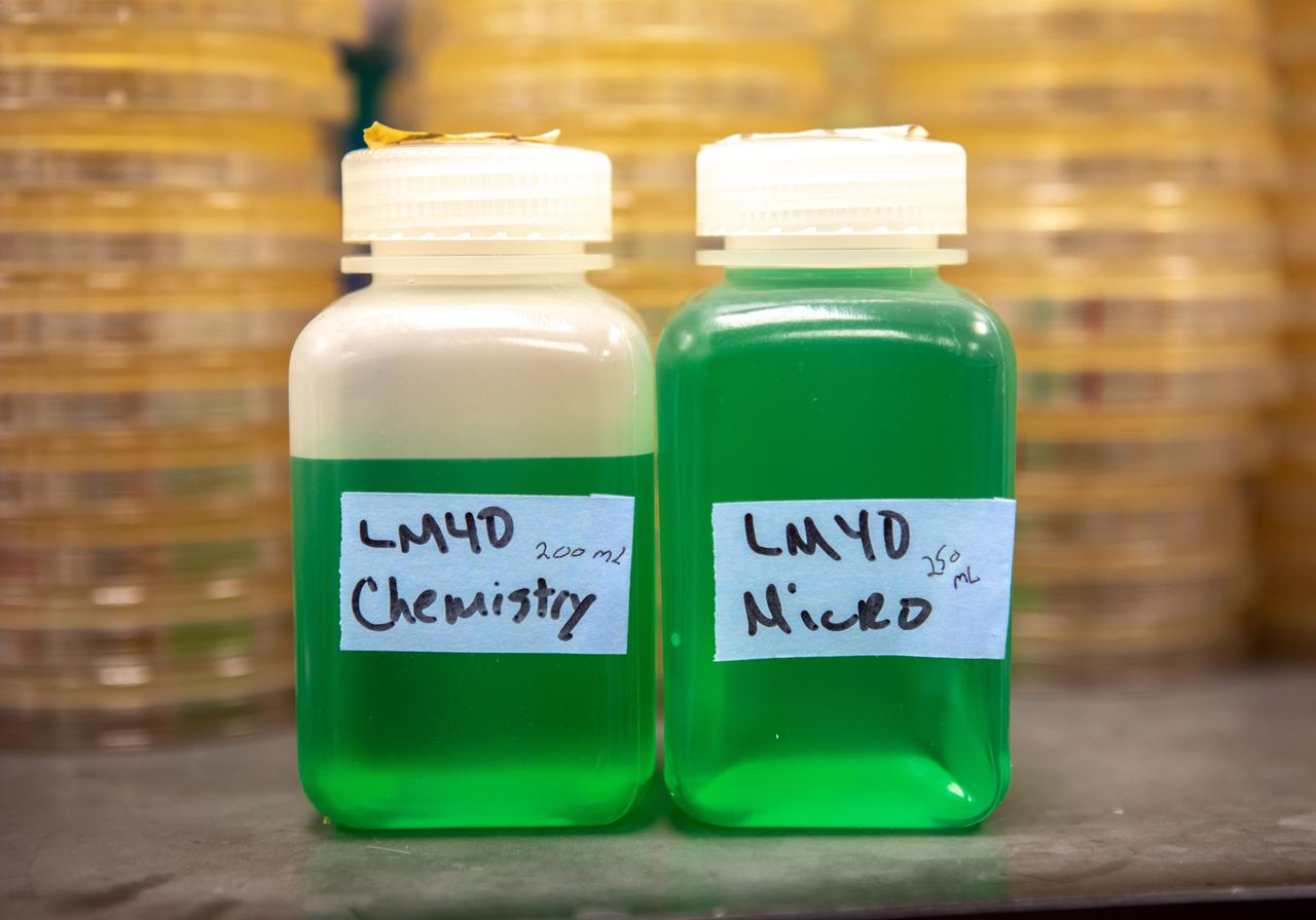 Samples of water, filled with green dye, gathered from two water tanks that have spent the past five years in space, are photographed inside the Neil Armstrong Operations and Checkout Building at NASA’s Kennedy Space Center in Florida on Nov. 13, 2019. The tanks were first sent to the International Space Station in 2014 to study slosh, or the movement of water, in a zero-gravity environment to help engineers predict the movement of propellant in rocket tanks. With the slosh experiment now concluded and the tanks recently returned to Kennedy, they are being utilized for a biological study to determine if there is, or was, any microbial growth within them. The results will help NASA determine whether clean water can be stored in space for long-duration missions, an essential component to keeping astronauts safe and healthy as the agency prepares for missions to the Moon and beyond to Mars. 