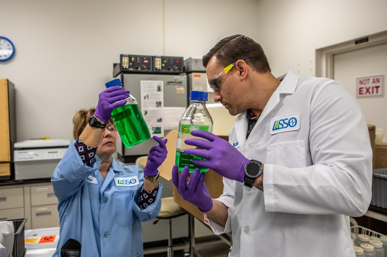 Kennedy Space Center’s Christina Khodadad, Ph.D., left, and Jason Fischer hold samples of water in the Florida spaceport’s Neil Armstrong Operations and Checkout Building on Nov. 13, 2019. Two tanks of water have recently returned to Kennedy after spending the last five years on the International Space Station for an experiment to study slosh, or the movement of water, in a zero-gravity environment to help engineers predict the movement of propellant in rocket tanks. Kennedy’s Air and Water Revitalization lab is studying the water tanks to determine if there is, or was, any microbial growth within them. The results will help NASA determine whether clean water can be stored in space for long-duration missions, an essential component to keeping astronauts safe and healthy as the agency prepares for missions to the Moon and beyond to Mars. 