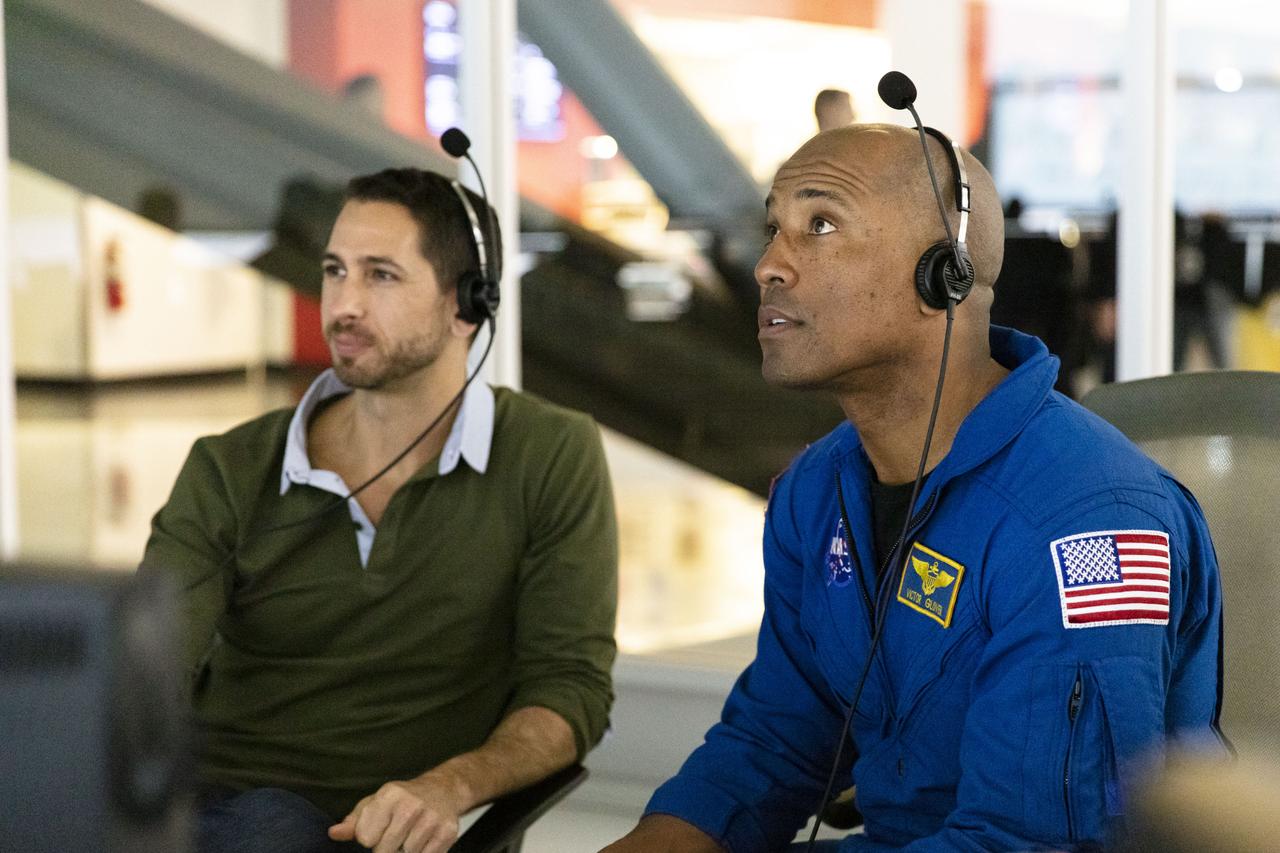 NASA astronaut Victor Glover, right, and a SpaceX employee, seated at consoles inside SpaceX Mission Control in Hawthorne, California, monitor the Crew Dragon spacecraft static fire engine tests taking place at Cape Canaveral Air Force Station in Florida on Nov. 13, 2019. The tests will help validate the Crew Dragon’s launch escape system ahead of the upcoming in-flight abort demonstration as part of NASA’s Commercial Crew Program. Glover will fly to the International Space Station on the second crewed flight of Crew Dragon.