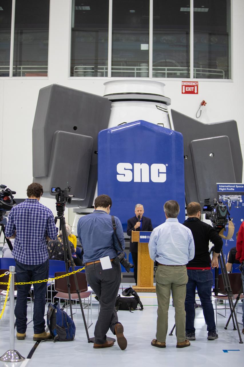Steve Lindsey, senior vice president of strategy for Sierra Nevada Corporation Space Systems and a former NASA astronaut, discusses the capabilities of the company’s Shooting Star cargo module during a media day event in the Space Station Processing Facility high bay at Kennedy Space Center on Nov. 19, 2019. Shooting Star will attach to the back of the company’s Dream Chaser spacecraft. The cargo module will deliver more than 12,000 pounds of supplies and other cargo to the International Space Station for NASA as part of the Commercial Resupply Services-2 contract.