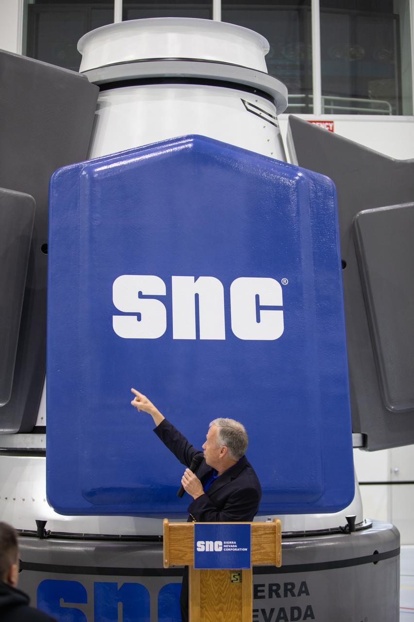 Steve Lindsey, senior vice president of strategy for Sierra Nevada Corporation Space Systems and a former NASA astronaut, discusses the capabilities of the company’s Shooting Star cargo module during a media day event in the Space Station Processing Facility high bay at Kennedy Space Center on Nov. 19, 2019. Shooting Star will attach to the back of the company’s Dream Chaser spacecraft. The cargo module will deliver more than 12,000 pounds of supplies and other cargo to the International Space Station for NASA as part of the Commercial Resupply Services-2 contract.