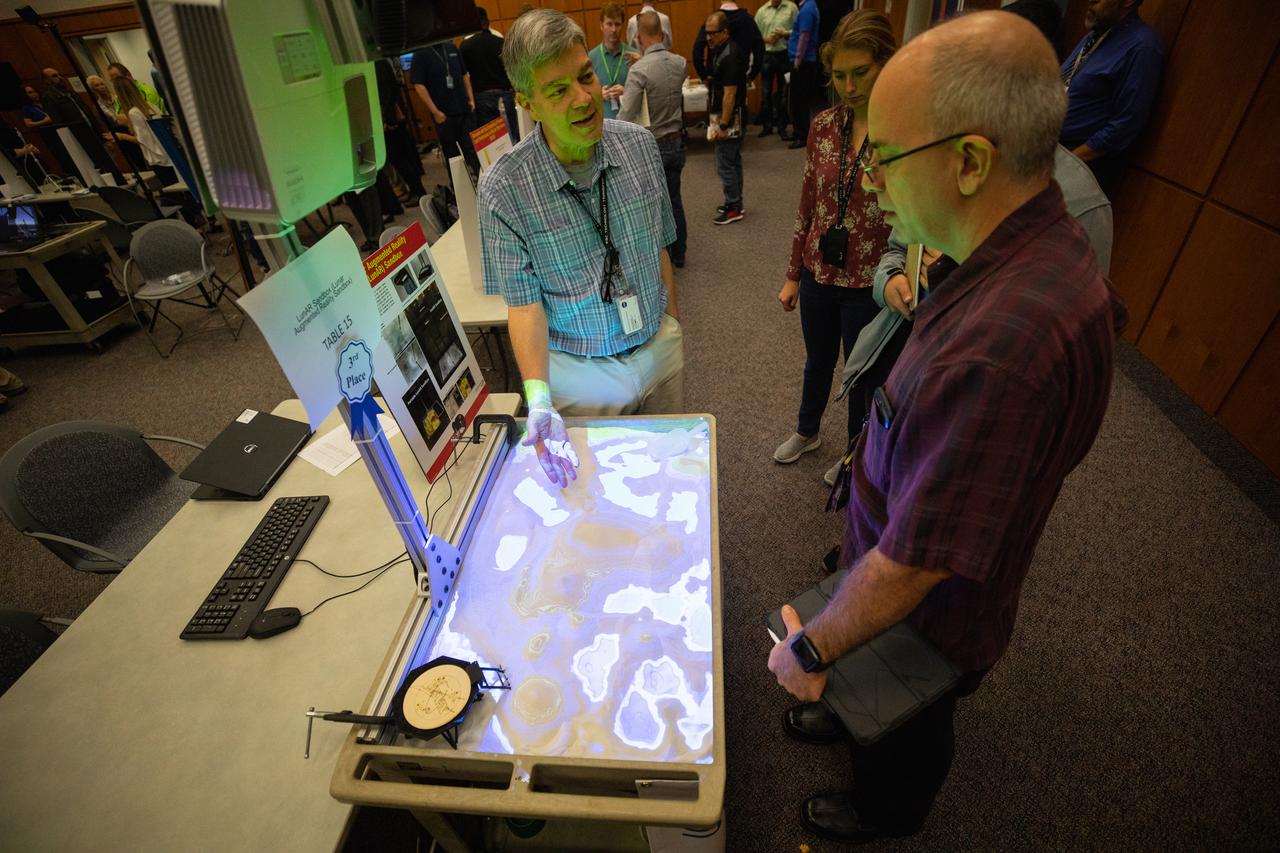 Kennedy Space Center employees participate in an innovation showcase on Nov. 19, 2019, in the Florida spaceport’s Neil Armstrong Operations and Checkout Building’s Mission Briefing Room. Nearly 50 exhibitors gathered to demonstrate new technologies and innovations during the center’s Innovation Days – one of several events throughout the year aimed at fostering and encouraging an innovative culture at Kennedy. Showcase participants included individuals from multiple directorates, programs and organizations throughout Kennedy. In addition to the showcase, employees had the opportunity to attend an overview presentation on NASA’s Human Landing System (HLS), hosted by HLS Program Manager Lisa Watson-Morgan.