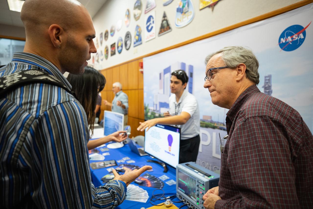 Two Kennedy Space Center employees engage in conversation during an innovation showcase on Nov. 19, 2019, in the Florida spaceport’s Neil Armstrong Operations and Checkout Building’s Mission Briefing Room. Nearly 50 exhibitors gathered to demonstrate new technologies and innovations during the center’s Innovation Days – one of several events throughout the year aimed at fostering and encouraging an innovative culture at Kennedy. Showcase participants included individuals from multiple directorates, programs and organizations throughout Kennedy. In addition to the showcase, employees had the opportunity to attend an overview presentation on NASA’s Human Landing System (HLS), hosted by HLS Program Manager Lisa Watson-Morgan.