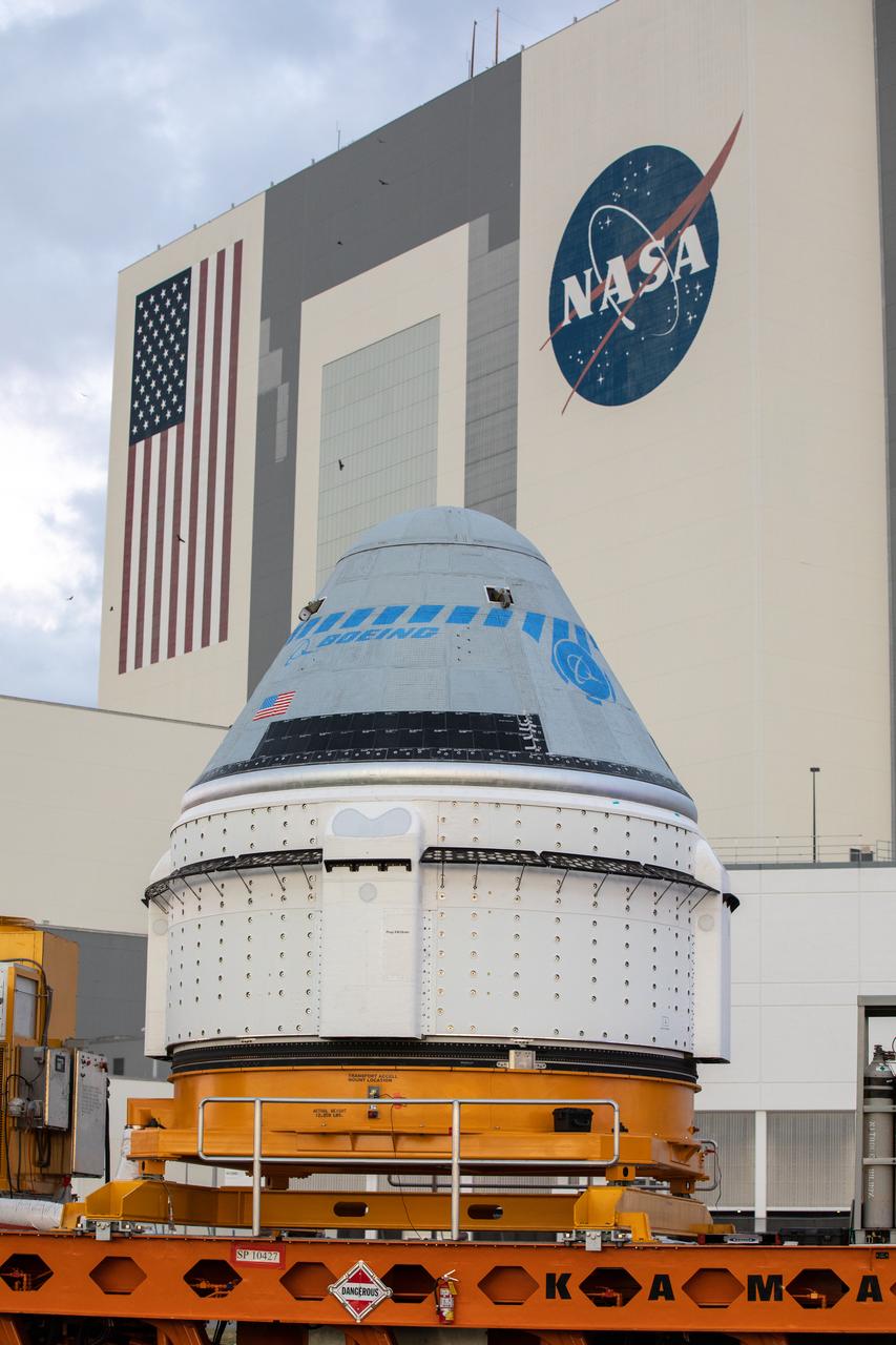 Boeing’s CST-100 Starliner spacecraft passes by the Vehicle Assembly Building at NASA’s Kennedy Space Center in Florida on Nov. 21, 2019, making its way to the Space Launch Complex 41 Vertical Integration Facility at Cape Canaveral Air Force Station. At the pad, Starliner will be secured atop a United Launch Alliance Atlas V rocket in preparation for Boeing’s uncrewed Orbital Flight Test to the International Space Station for NASA’s Commercial Crew Program.