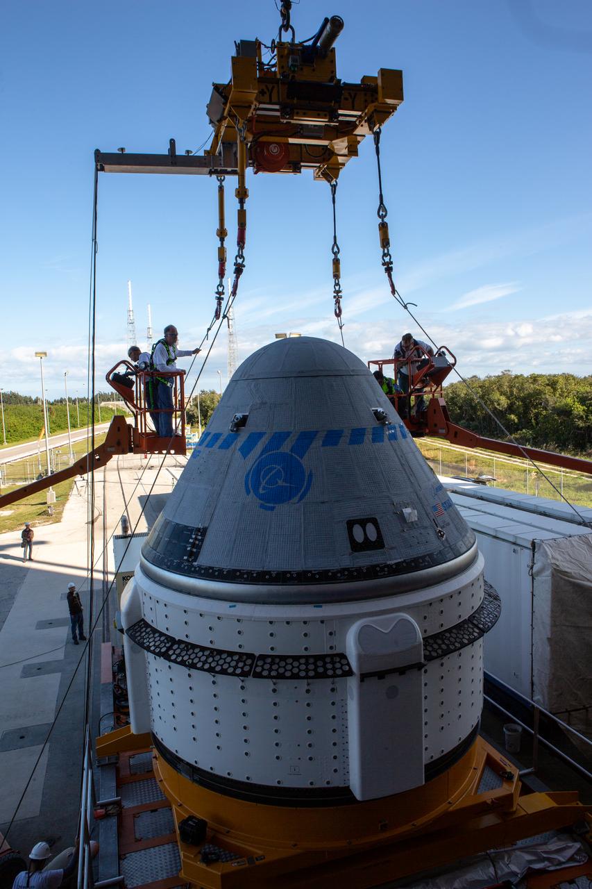 The Boeing CST-100 Starliner spacecraft is lifted at the Vertical Integration Facility at Space Launch Complex 41 at Florida’s Cape Canaveral Air Force Station on Nov. 21, 2019. Starliner will be secured atop a United Launch Alliance Atlas V rocket for Boeing’s Orbital Flight Test to the International Space Station for NASA’s Commercial Crew Program. The spacecraft rolled out from Boeing’s Commercial Crew and Cargo Processing Facility at NASA’s Kennedy Space Center earlier in the day.