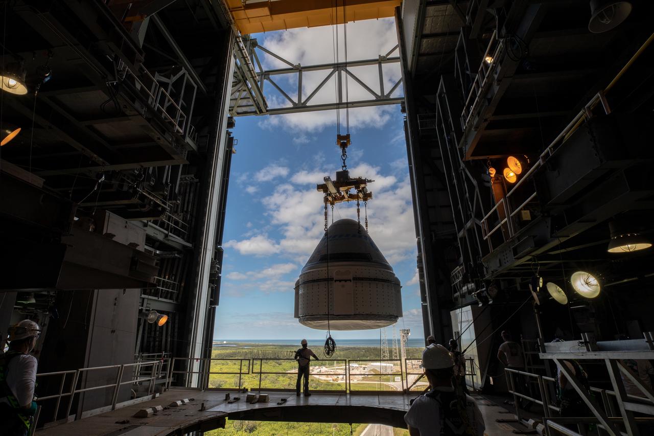 The Boeing CST-100 Starliner spacecraft is guided into position above a United Launch Alliance Atlas V rocket at the Vertical Integration Facility at Space Launch Complex 41 at Florida’s Cape Canaveral Air Force Station on Nov. 21, 2019. Starliner will be secured atop the rocket for Boeing’s Orbital Flight Test to the International Space Station for NASA’s Commercial Crew Program. The spacecraft rolled out from Boeing’s Commercial Crew and Cargo Processing Facility at NASA’s Kennedy Space Center earlier in the day.