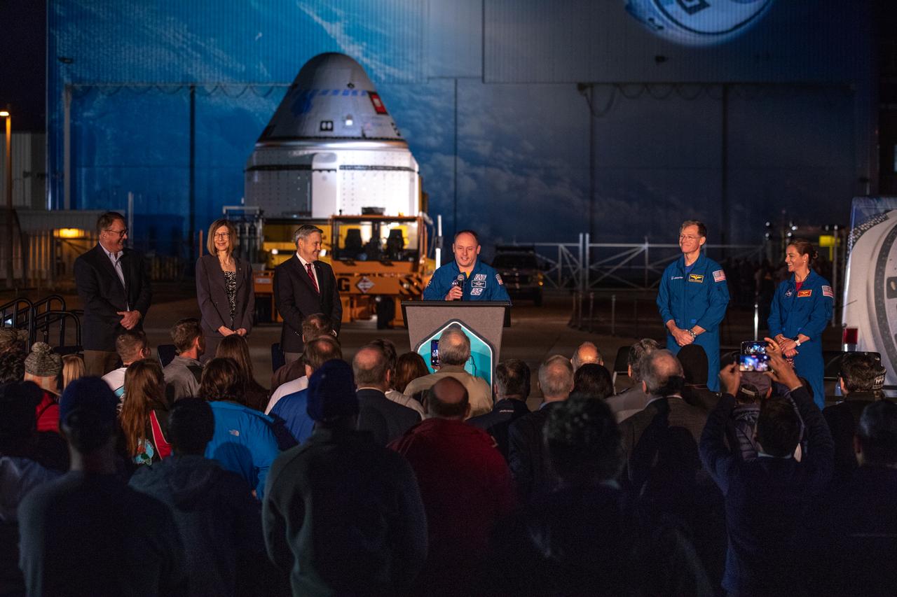 NASA astronaut Mike Fincke speaks during the Boeing CST-100 Starliner spacecraft rollout from the company’s Commercial Crew and Cargo Processing Facility at Kennedy Space Center in Florida on Nov. 21, 2019. To his left are Boeing astronaut Chris Ferguson and NASA astronaut Nicole Mann. To Fincke’s right (from left to right) are John Mulholland, Boeing vice president and program manager, Commercial Crew Program; NASA’s Commercial Crew Program Manager Kathy Lueders and Kennedy Space Center Director Bob Cabana. Starliner will make the trip to Space Launch Complex 41 at Cape Canaveral Air Force Station where it will be secured atop a United Launch Alliance Atlas V rocket for Boeing’s Orbital Flight Test to the International Space Station for NASA’s Commercial Crew Program.