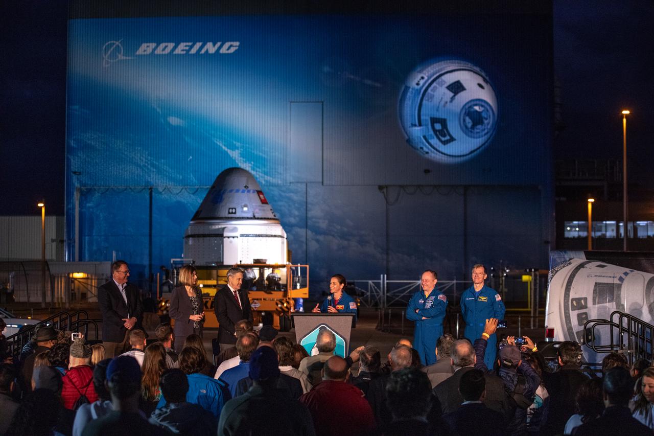NASA astronaut Nicole Mann speaks during the Boeing CST-100 Starliner spacecraft rollout from the company’s Commercial Crew and Cargo Processing Facility at Kennedy Space Center in Florida on Nov. 21, 2019. To her left (from left to right) are NASA astronaut Mike Fincke and Boeing astronaut Chris Ferguson. To Mann’s right (from left to right) are John Mulholland, Boeing vice president and program manager, Commercial Crew Program; NASA’s Commercial Crew Program Manager Kathy Lueders and Kennedy Director Bob Cabana. Starliner will make the trip to Space Launch Complex 41 at Cape Canaveral Air Force Station where it will be secured atop a United Launch Alliance Atlas V rocket for Boeing’s Orbital Flight Test to the International Space Station for NASA’s Commercial Crew Program.