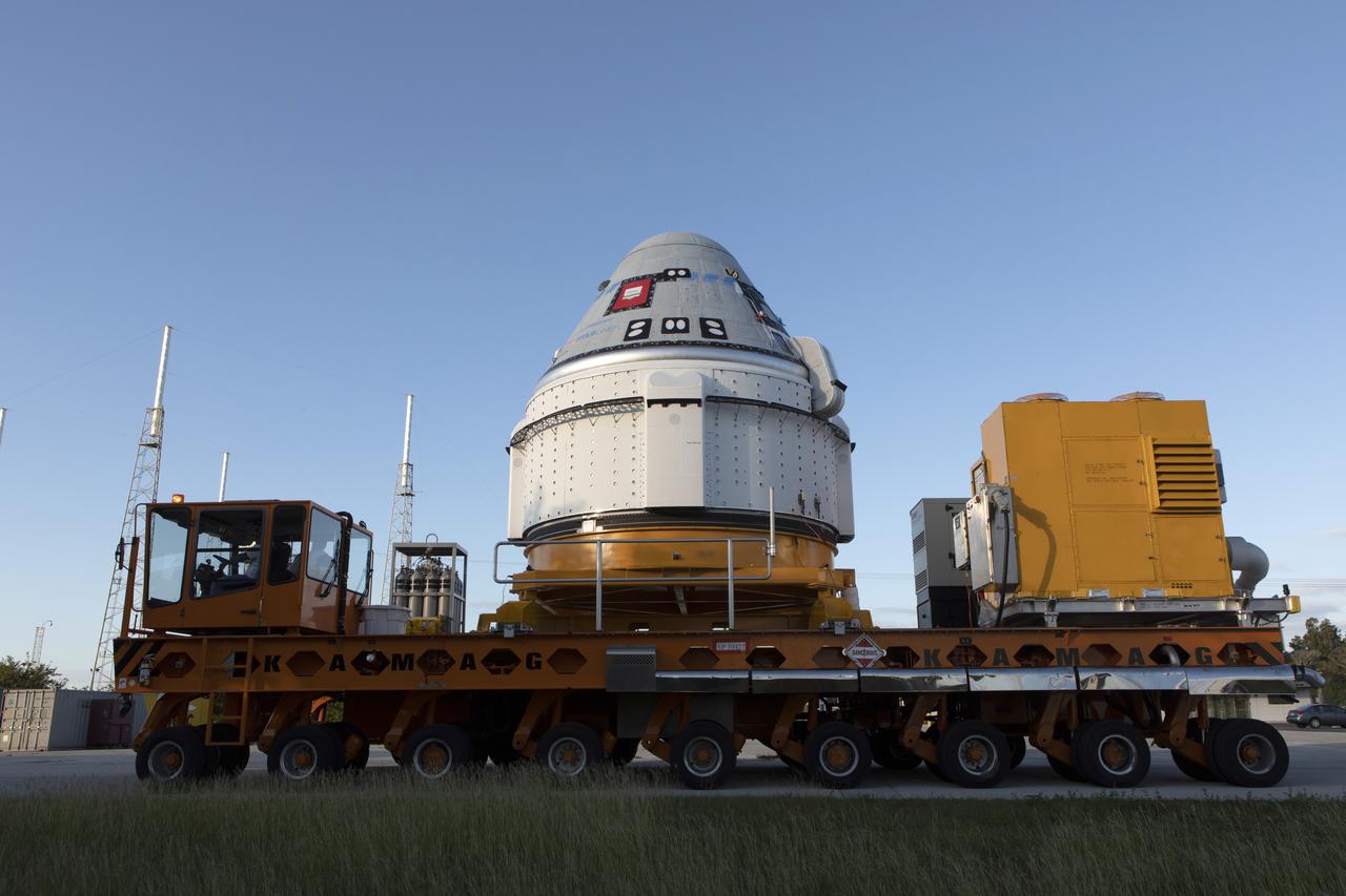 The Boeing CST-100 Starliner spacecraft arrives at the Vertical Integration Facility  at Space Launch Complex 41 at Cape Canaveral Air Force Station in Florida on Nov. 21, 2019. Starliner will be secured atop a United Launch Alliance Atlas V rocket for Boeing’s Orbital Flight Test to the International Space Station for NASA’s Commercial Crew Program. The spacecraft rolled out from Boeing’s Commercial Crew and Cargo Processing Facility at NASA’s Kennedy Space Center earlier in the day.