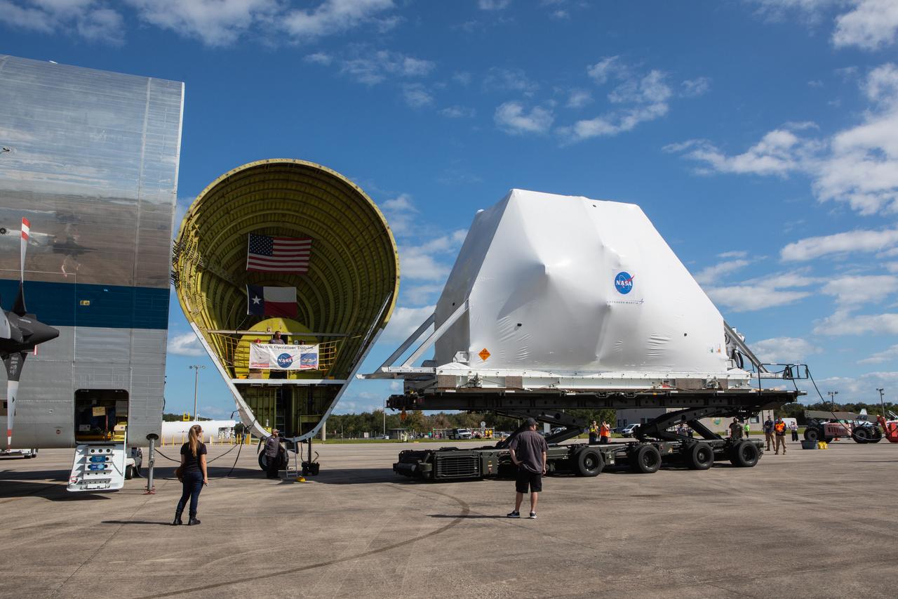 NASA’s Orion spacecraft, wrapped up for shipping, arrives at Kennedy Space Center’s Launch and Landing Facility runway for loading into the agency’s Super Guppy aircraft on Nov. 21, 2019. The spacecraft’s crew and service modules are flying from the Florida spaceport to NASA’s Plum Brook Station in Sandusky, Ohio, for full thermal vacuum testing. In this unique facility, the crew and service modules will be put through extensive testing to ensure they can survive the rigors of launch, space travel, re-entry and splashdown. The Orion spacecraft will launch atop the agency's Space Launch System rocket on Artemis I.
