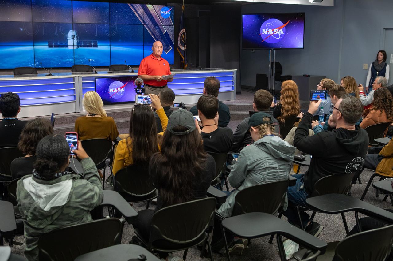 Greg Harland, NASA Communications, moderates a What’s On Board Briefing for SpaceX’s 19th Commercial Resupply Services (CRS-19) mission for NASA to the International Space Station on Dec. 3, 2019, at the agency’s Kennedy Space Center in Florida. The SpaceX Falcon 9 rocket and Dragon cargo module are scheduled to launch on Dec. 4, 2019, from Space Launch Complex 40 on Cape Canaveral Air Force Station in Florida. 