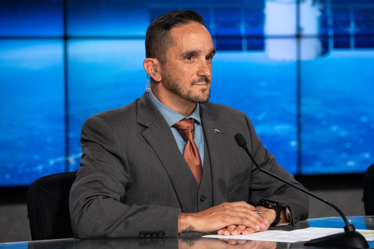 Dustin Cammack, NASA Communications, moderates a prelaunch news conference on Dec. 3, 2019, for SpaceX’s 19th Commercial Resupply Services (CRS-19) mission for NASA to the International Space Station, at the agency’s Kennedy Space Center in Florida. NASA and industry leaders speak to members of the news media during the news conference. The SpaceX Falcon 9 rocket and Dragon cargo module are scheduled to launch on Dec. 4, 2019, from Space Launch Complex 40 on Cape Canaveral Air Force Station in Florida.