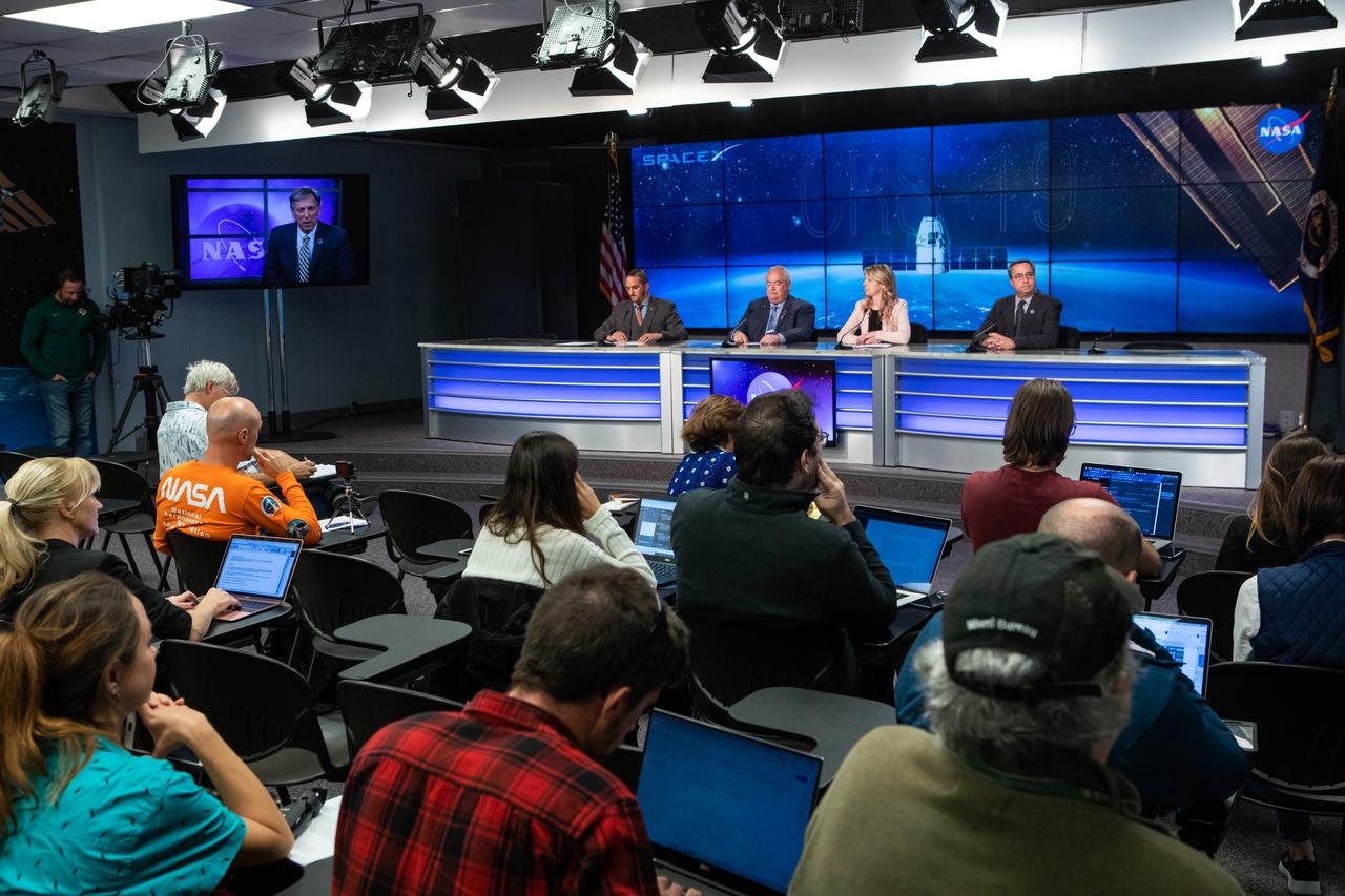 Dustin Cammack, NASA Communications, far left, moderates a prelaunch news conference on Dec. 3, 2019, for SpaceX's 19th Commercial Resupply Services (CRS-19) mission for NASA to the International Space Station, at the agency’s Kennedy Space Center in Florida. Speaking to members of the news media are, from left, Bryan Dansbury, assistant program scientist, International Space Station Program Science Office at NASA; Jessica Jensen, director, Dragon Mission Management at SpaceX; and Mike McAleenan, launch weather officer, U.S. Air Force 45th Space Wing. The SpaceX Flacon 9 rocket and Dragon cargo module are scheduled to launch on Dec. 4, 2019, from Space Launch Complex 40 on Cape Canaveral Air Force Station in Florida.