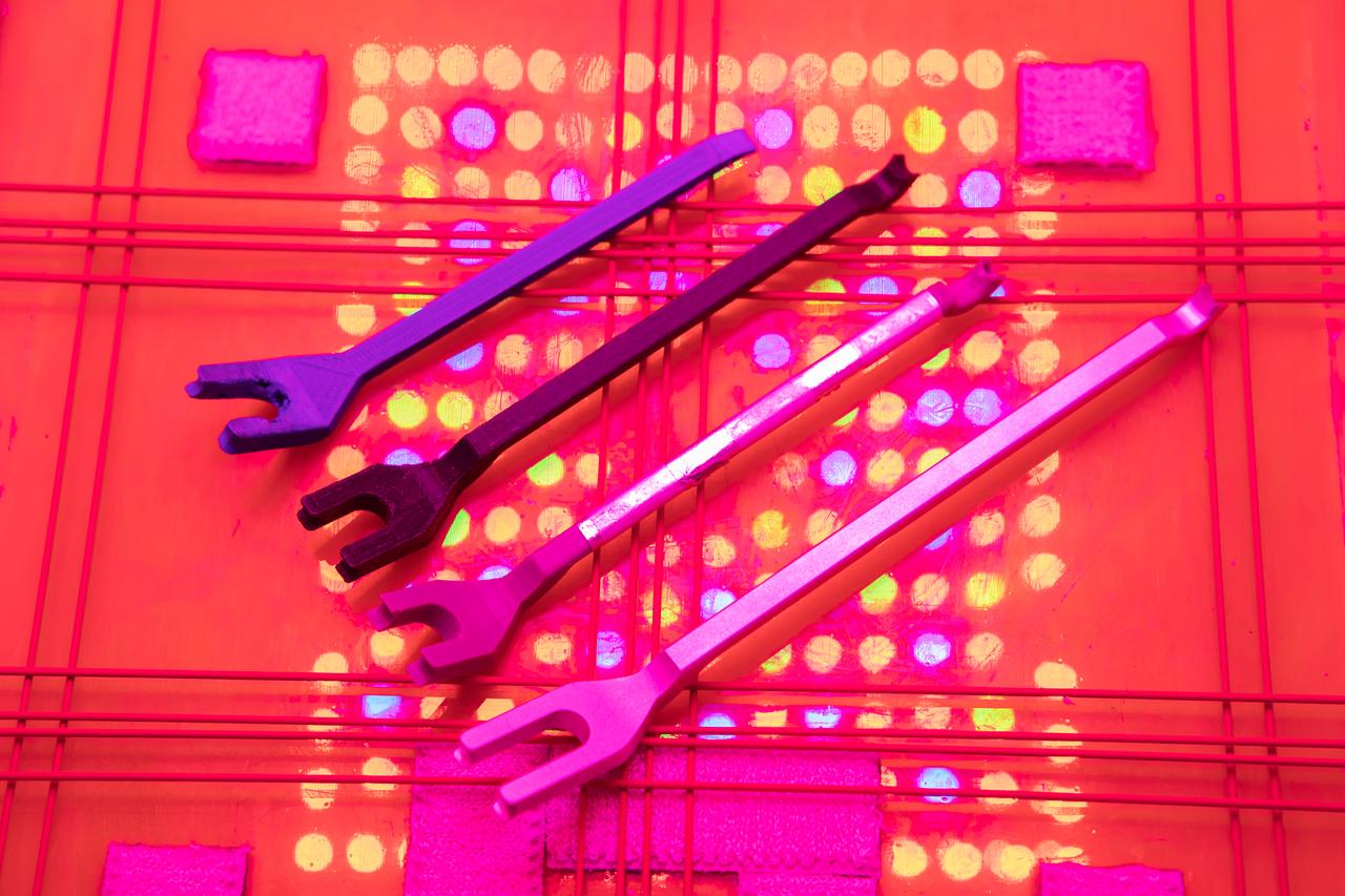 This photograph shows the evolution of the bungee tool as it went from a simple, 3D-printed object to an increasingly refined tool designed to save astronauts time when they work with the bungee system in the Veggie plant chamber aboard the International Space Station. The bungee tool is utilized to manipulate the bungee cords that help secure vital parts of plant experiments on the orbiting laboratory. 
