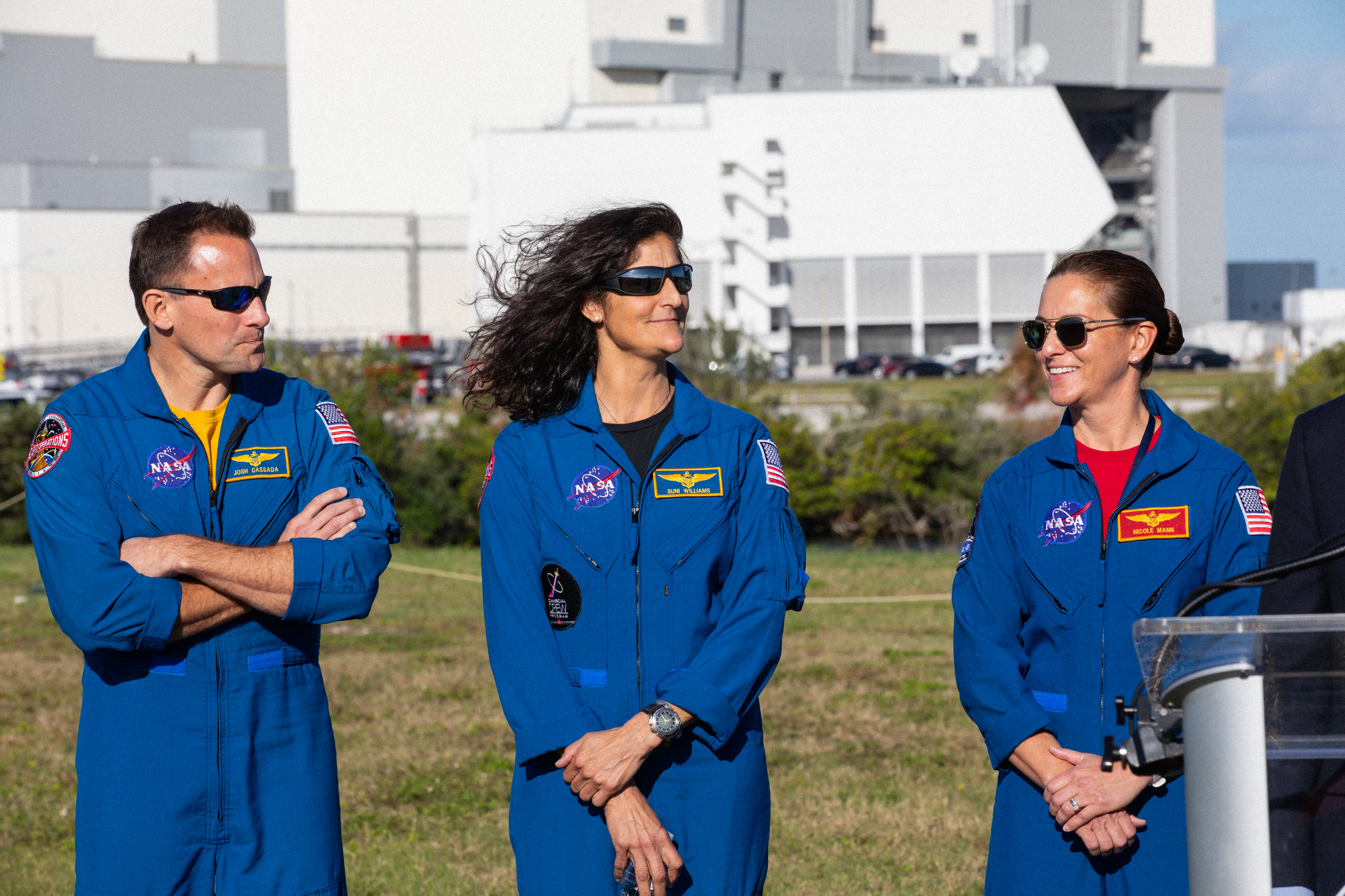 From left, NASA astronauts Josh Cassada, Suni Williams and Nicole Mann participate in a Boeing Orbital Flight Test media briefing near the countdown clock at the Florida spaceport on Dec. 19, 2019. Boeing’s CST-100 Starliner spacecraft will launch atop a United Launch Alliance Atlas V rocket from Space Launch Complex 41 at Cape Canaveral Air Force Station. The uncrewed Orbital Flight Test will be the Starliner’s first flight to the International Space Station for NASA’s Commercial Crew Program. 