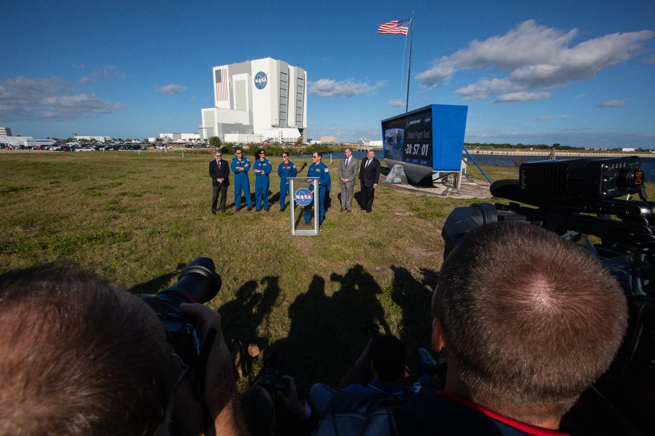 Chris Ferguson, Boeing astronaut, participates in a Boeing Orbital Flight Test media briefing near the countdown clock at the Florida spaceport on Dec. 19, 2019. In the background from left to right are Kennedy Space Center Director Bob Cabana; NASA astronauts Josh Cassada, Suni Williams and Nicole Mann; NASA Administrator Jim Bridenstine; and Deputy Administrator Jim Morhard. Boeing’s CST-100 Starliner spacecraft will launch atop a United Launch Alliance Atlas V rocket from Space Launch Complex 41 at Cape Canaveral Air Force Station. The uncrewed Orbital Flight Test will be the Starliner’s first flight to the International Space Station for NASA’s Commercial Crew Program.
