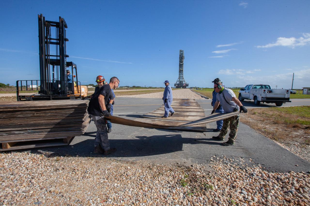 Kennedy Space Center employees lay out a path for NASA’s mobile launcher, carried atop the crawler-transporter 2, to continue its journey to the Vehicle Assembly Building (VAB) on Dec. 20, 2019. The mobile launcher returned to the VAB after spending months at the Florida spaceport’s Launch Pad 39B undergoing final validation and verification testing. Standing 380 feet tall, the mobile launcher – which will be used to assemble, process and launch the Space Launch System and Orion spacecraft – will remain inside the VAB until it is ready to return to the pad with the rocket and spacecraft on top for the “wet dress rehearsal” ahead of the Artemis I launch.