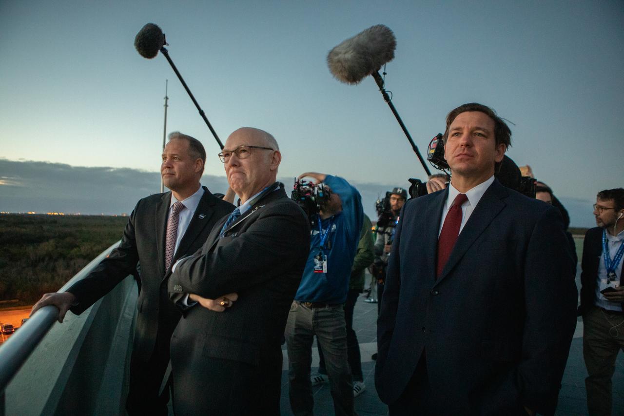 From left to right, NASA Administrator Jim Bridenstine; Tory Bruno, president and chief executive officer of United Launch Alliance; and Florida Governor Ron DeSantis wait at NASA’s Kennedy Space Center in Florida to see the liftoff of a United Launch Alliance Atlas V rocket carrying Boeing’s CST-100 Starliner spacecraft for Boeing’s Orbital Flight Test, Dec. 20, 2019. Liftoff occurred at 6:36 a.m. EST from Space Launch Complex 41 at Florida’s Cape Canaveral Air Force Station. The uncrewed Orbital Flight Test is the Starliner’s first flight for NASA’s Commercial Crew Program.