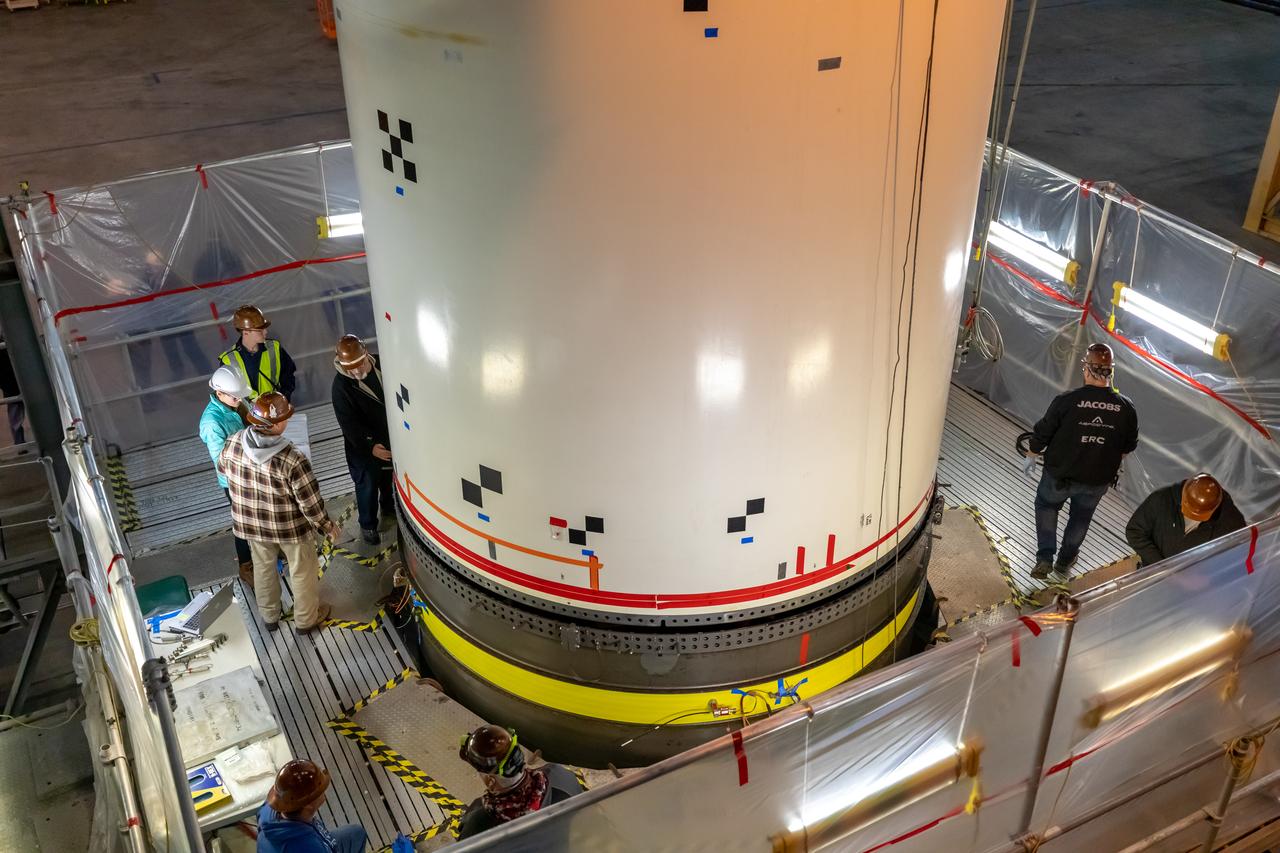 In High Bay 4 of the Vehicle Assembly Building at NASA’s Kennedy Space Center in Florida, a team of engineers with Exploration Ground Systems and contractor Jacobs participate in Space Launch System (SLS) solid rocket booster pathfinder stacking during a training exercise on Jan. 8, 2020. The booster pathfinders are inert, full-scale replicas of the actual booster hardware that will be attached to the SLS rocket for Artemis missions. The team is practicing lifting, moving and stacking maneuvers, using important ground support equipment to train employees and certify all the equipment works properly. The five-segment, 17-story-tall twin boosters will provide 3.6 million pounds of thrust each at liftoff to help launch Orion on Artemis I, its first uncrewed mission beyond the Moon.