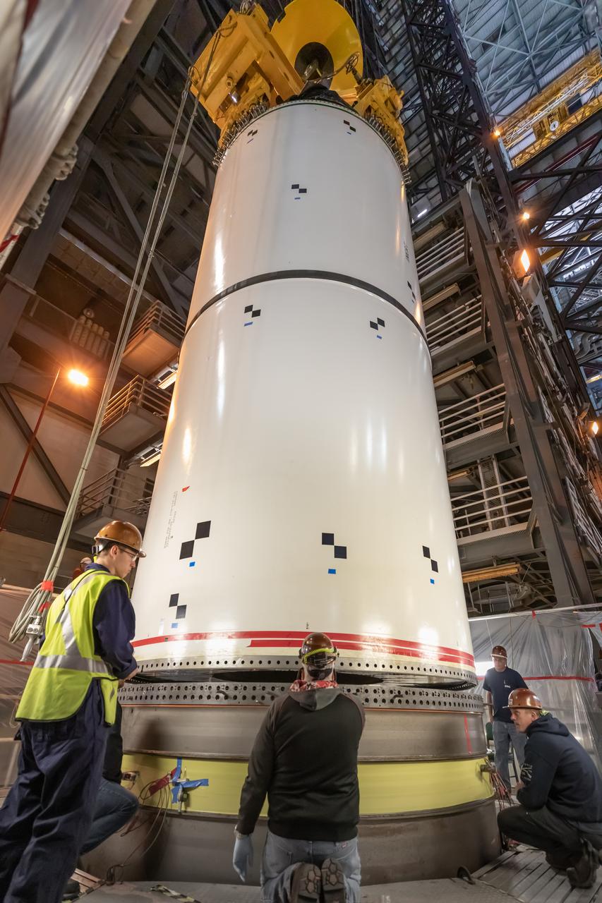 In High Bay 4 of the Vehicle Assembly Building at NASA’s Kennedy Space Center in Florida, a team of engineers with Exploration Ground Systems and contractor Jacobs participate in Space Launch System (SLS) solid rocket booster pathfinder stacking during a training exercise on Jan. 8, 2020. The booster pathfinders are inert, full-scale replicas of the actual booster hardware that will be attached to the SLS rocket for Artemis missions. The team is practicing lifting, moving and stacking maneuvers, using important ground support equipment to train employees and certify all the equipment works properly. The five-segment, 17-story-tall twin boosters will provide 3.6 million pounds of thrust each at liftoff to help launch Orion on Artemis I, its first uncrewed mission beyond the Moon.