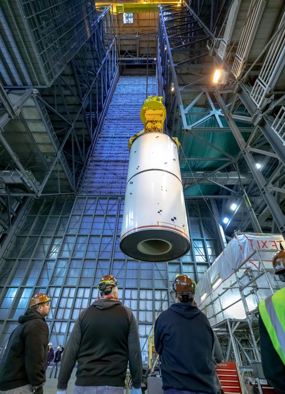 In High Bay 4 of the Vehicle Assembly Building at NASA’s Kennedy Space Center in Florida, a team of engineers with Exploration Ground Systems and contractor Jacobs participate in Space Launch System (SLS) solid rocket booster pathfinder stacking during a training exercise on Jan. 8, 2020. A crane is used to lift up two pathfinder segments and move them to a platform. The booster pathfinders are inert, full-scale replicas of the actual booster hardware that will be attached to the SLS rocket for Artemis missions. The team is practicing lifting, moving and stacking maneuvers, using important ground support equipment to train employees and certify all the equipment works properly. The five-segment, 17-story-tall twin boosters will provide 3.6 million pounds of thrust each at liftoff to help launch Orion on Artemis I, its first uncrewed mission beyond the Moon.