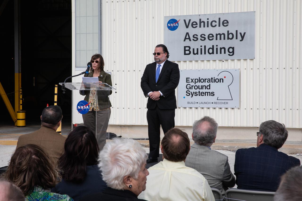 Carol Stevens, History and Heritage Committee member with the American Society of Civil Engineers (ASCE), speaks to attendees during a ceremony on Jan. 10, 2020, to recognize the Vehicle Assembly Building with the National Historic Civil Engineering Landmark award. At right is Peter Moore, ASCE Region 5 director. The Florida Section ASCE nominated the historic building and bestowed the award. The VAB is the first building at Kennedy Space Center to earn this distinction. At the time of its completion, the 129-million-cubic-foot structure was the largest building in the world. Originally designed and built to accommodate the Saturn V/Apollo used in Project Apollo, the VAB was later modified for its role in the Space Shuttle Program.