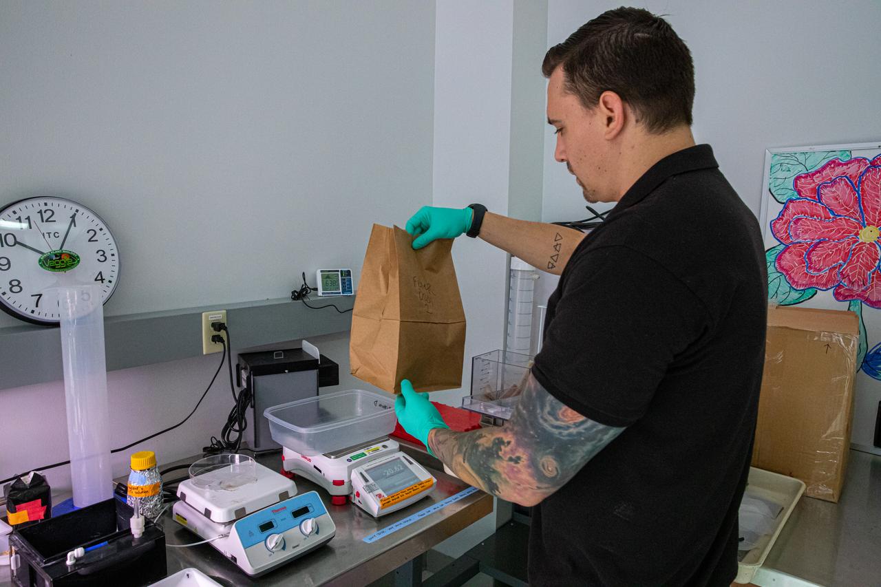On Jan. 15, 2020, Jason Fischer, a research scientist with the Laboratory Support Services and Operations contract at NASA’s Kennedy Space Center in Florida, prepares to weigh peppers that were grown and harvested inside the Space Station Processing Facility in preparation for sending them to space. As NASA prepares to send humans beyond low-Earth orbit, the ability for astronauts to grow a variety of fresh fruits and vegetables in space will be critical. Fresh produce will be an essential supplement to the crew’s pre-packaged diet during long-duration space exploration when they are away from Earth for extended periods of time. 