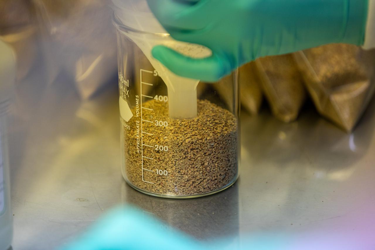 Inside the Space Station Processing Facility at NASA’s Kennedy Space Center in Florida, a researcher measures out the calcined clay that will be used to assemble plant pillows on Jan. 16, 2019. Often used to condition baseball infields, the clay’s size and roughness traps air and absorbs water to provide both to plant roots in microgravity. The pillows are small containers used to grow plants in space aboard the International Space Station. These pillows are for a series of plant experiments called VEG-03 J/K/L that will monitor the growth of three types of leafy greens and test a new way of handling seeds. The experiments will be launched to the orbiting laboratory aboard a Northrop Grumman Antares rocket and Cygnus spacecraft on the company’s 13th resupply services mission. Liftoff is scheduled for Feb. 9, 2020, at 5:39 p.m. EST from the agency’s Wallops Flight Facility in Virginia. 