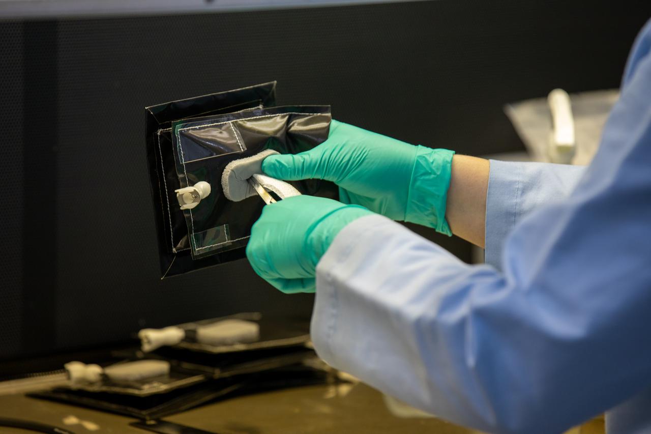 Jess Bunchek, a pseudonaut and associate scientist at NASA’s Kennedy Space Center in Florida, places the seed wick – which plant seeds will be glued into later – in a plant pillow inside the Space Station Processing Facility on Jan. 16, 2020. A common method used to grow plants in space, the pillows are being sent to the International Space Station for a series of VEG-03 experiments that will study the growth of three types of leafy greens and a new seed handling material in a microgravity environment. The experiments will be launched to the orbiting laboratory aboard a Northrop Grumman Antares rocket and Cygnus spacecraft on the company’s 13th resupply services mission. Liftoff is scheduled for Feb. 9, 2020, at 5:39 p.m. EST from the agency’s Wallops Flight Facility in Virginia. 