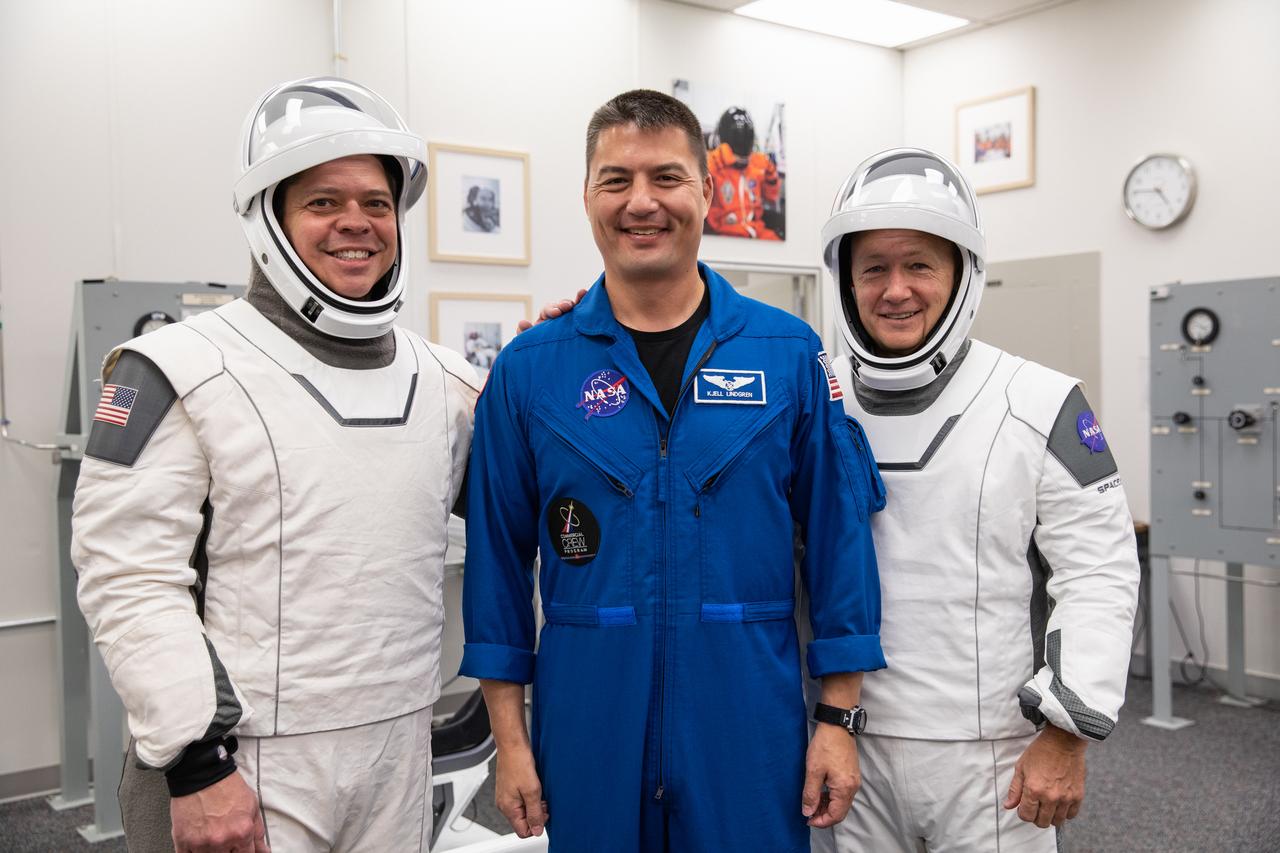 From left to right, NASA astronauts Bob Behnken, Kjell Lindgren and Doug Hurley pause for a photo in the Astronaut Crew Quarters at Kennedy Space Center in Florida on Jan. 17, 2020, during a dress rehearsal ahead of the SpaceX uncrewed In-Flight Abort Test. Behken and Hurley are wearing SpaceX spacesuits. A SpaceX Falcon 9 rocket and Crew Dragon spacecraft will lift off from Launch Complex 39A on the flight test, which will demonstrate the spacecraft’s escape capabilities in preparation for crewed flights to the International Space Station as part of the agency’s Commercial Crew Program. Behnken and Hurley are slated to fly on the company’s first crewed mission, Demo-2.