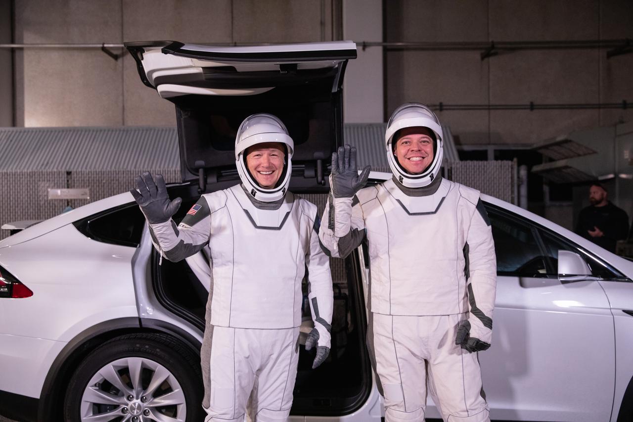 NASA astronauts Doug Hurley, left, and Bob Behnken, wearing SpaceX spacesuits, wave after walking out of the Neil A. Armstrong Operations and Checkout Building at Kennedy Space Center in Florida on Jan. 17, 2020, during a dress rehearsal ahead of the SpaceX uncrewed In-Flight Abort Test. A SpaceX Falcon 9 rocket and Crew Dragon spacecraft will lift off from Launch Complex 39A on the flight test, which will demonstrate the spacecraft’s escape capabilities in preparation for crewed flights to the International Space Station as part of the agency’s Commercial Crew Program. Behnken and Hurley are slated to fly on the company’s first crewed mission, Demo-2.