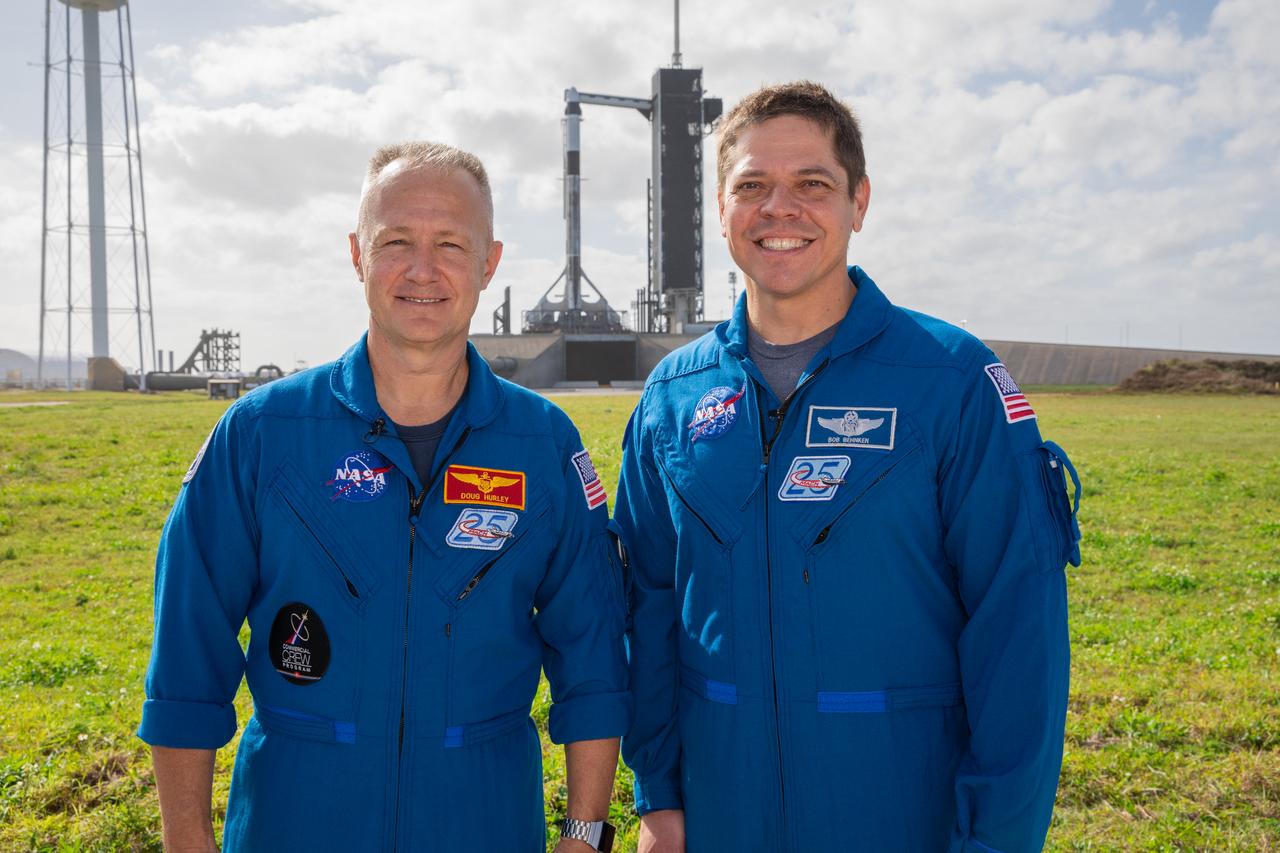 NASA astronauts Doug Hurley, left, and Bob Behnken stand near Launch Pad 39A at the agency’s Kennedy Space Center in Florida on Jan. 17, 2020, during a dress rehearsal ahead of the SpaceX uncrewed In-Flight Abort Test. In the background, the company’s Falcon 9 rocket is topped by the Crew Dragon spacecraft. The flight test will demonstrate the spacecraft’s escape capabilities in preparation for crewed flights to the International Space Station as part of the agency’s Commercial Crew Program. Hurley and Behnken are slated to fly on the company’s first crewed mission, Demo-2.