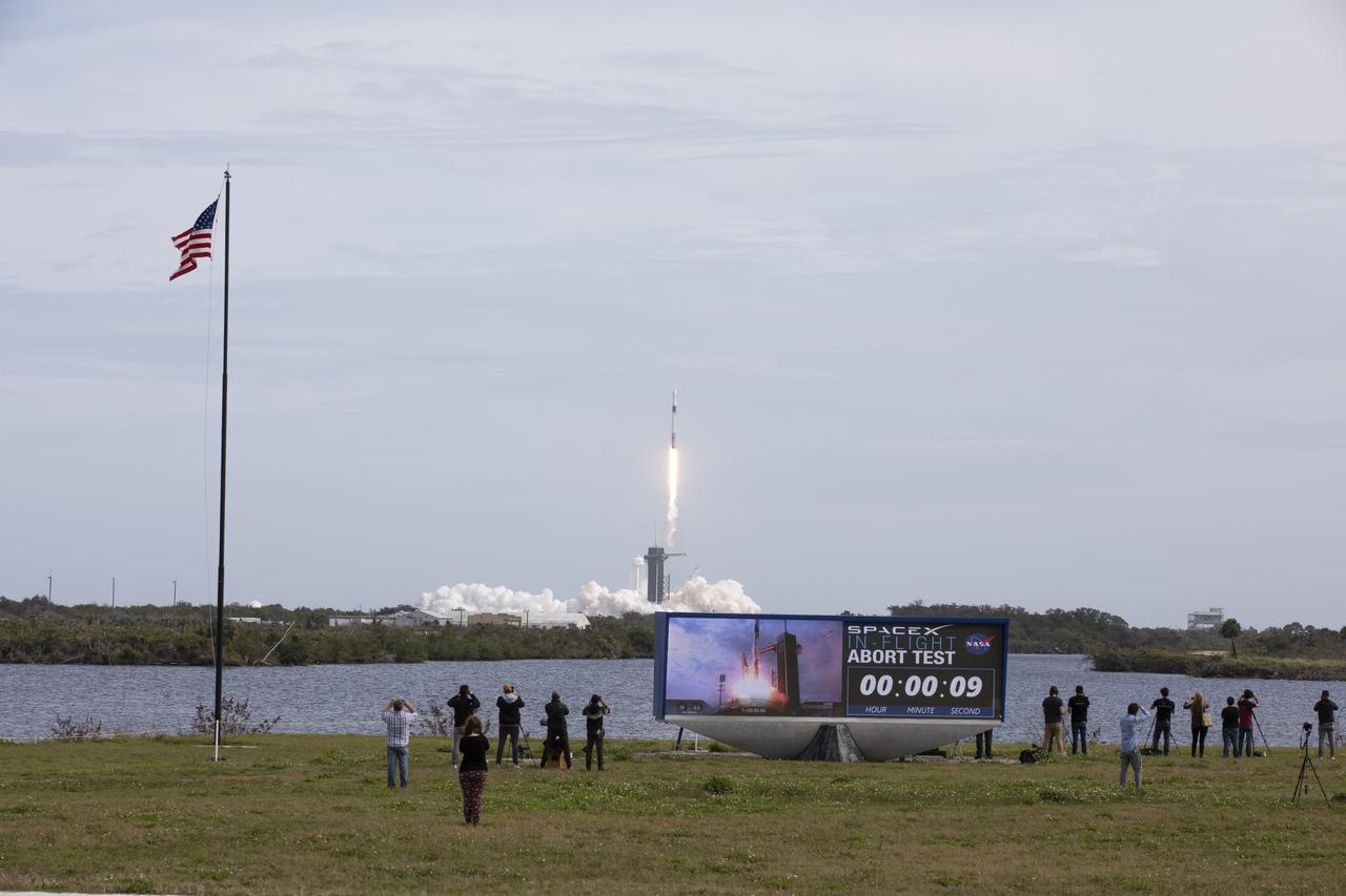 The countdown clock at NASA’s Kennedy Space Center in Florida shows an elapsed time of nine seconds as the SpaceX Falcon 9 rocket lifts off from Launch Complex 39A on the uncrewed In-Flight Abort Test, Jan. 19, 2020. The rocket carried the company’s Crew Dragon on a flight test that demonstrated the spacecraft’s escape capabilities in preparation for crewed flights to the International Space Station as part of the agency’s Commercial Crew Program. 