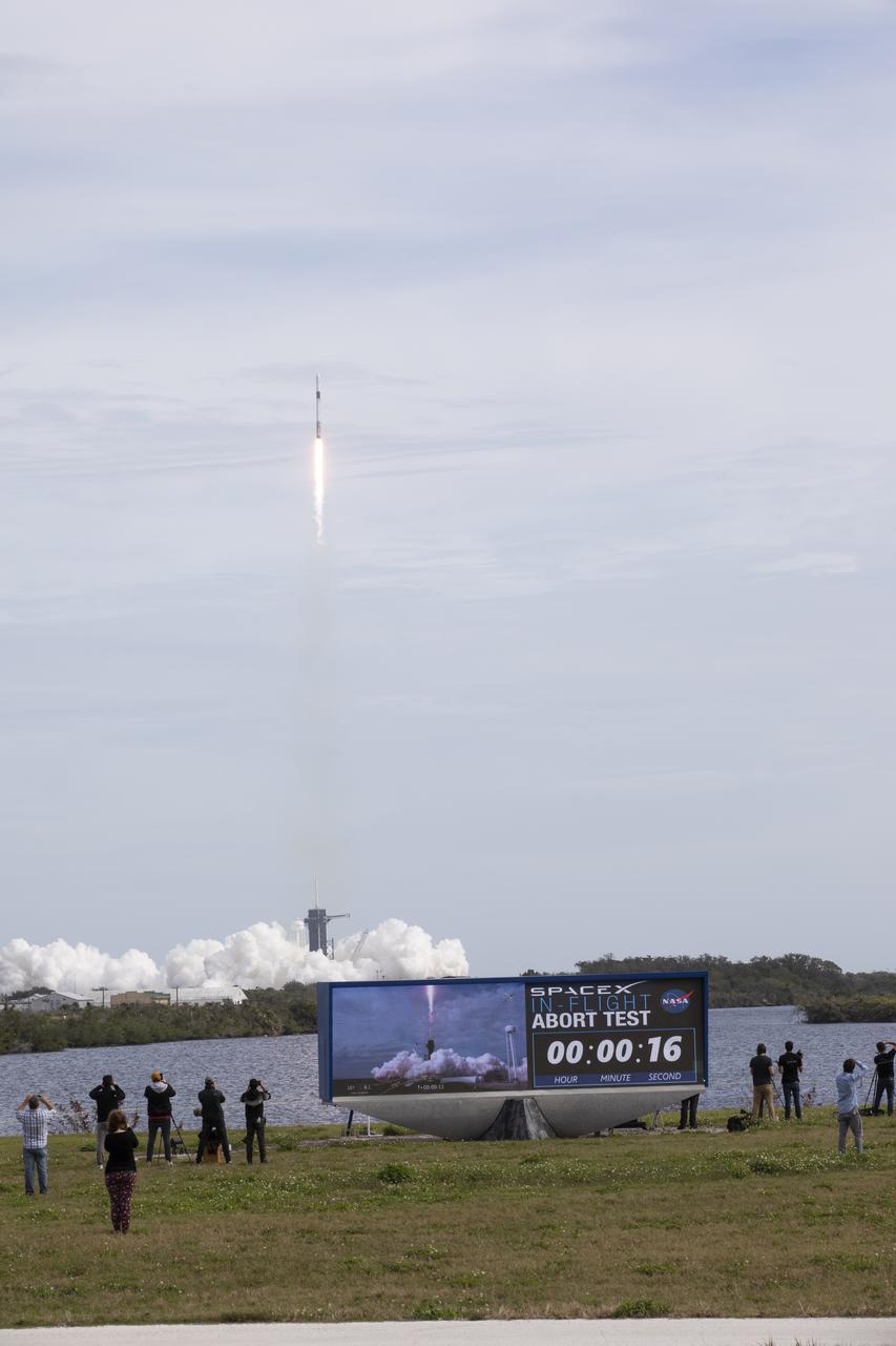 The countdown clock at NASA’s Kennedy Space Center in Florida shows an elapsed time of 16 seconds as the SpaceX Falcon 9 rocket lifts off from Launch Complex 39A on the uncrewed In-Flight Abort Test, Jan. 19, 2020. The rocket carried the company’s Crew Dragon on a flight test that demonstrated the spacecraft’s escape capabilities in preparation for crewed flights to the International Space Station as part of the agency’s Commercial Crew Program. 