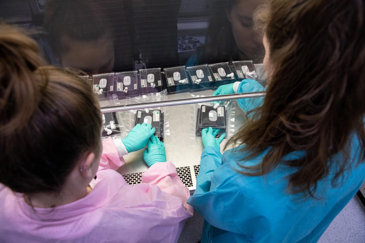 On Jan. 21, 2020, inside the Space Station Processing Facility at NASA’s Kennedy Space Center in Florida, intern Emily Kennebeck (left) and Jess Bunchek, a pseudonaut and associate scientist, prepare plant pillows for their upcoming flight to the International Space Station. The pillows, which are a common method used to grow plants in space, are being sent to the orbiting laboratory on Northrop Grumman’s 13th resupply services (NG-13) mission for a series of VEG-03 experiments that will study the growth of three types of leafy greens in a microgravity environment. Once the pillows are assembled and packaged for flight, they will be transported to the agency’s Wallops Flight Facility in Virginia, where liftoff will occur. NG-13 is scheduled to launch on Feb. 9, 2020, at 5:39 p.m. EST. 