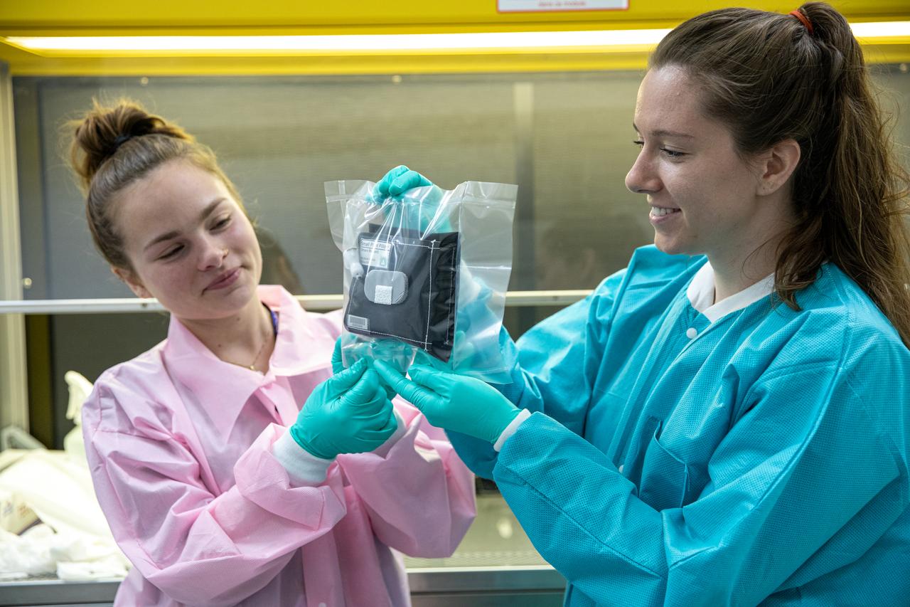 On Jan. 21, 2020, inside the Space Station Processing Facility at NASA’s Kennedy Space Center in Florida, intern Emily Kennebeck (left) and Jess Bunchek, a pseudonaut and associate scientist, prepare plant pillows for their upcoming flight to the International Space Station. The pillows, which are a common method used to grow plants in space, are being sent to the orbiting laboratory on Northrop Grumman’s 13th resupply services (NG-13) mission for a series of VEG-03 experiments that will study the growth of three types of leafy greens in a microgravity environment. Once the pillows are assembled and packaged for flight, they will be transported to the agency’s Wallops Flight Facility in Virginia, where liftoff will occur. NG-13 is scheduled to launch on Feb. 9, 2020, at 5:39 p.m. EST. 