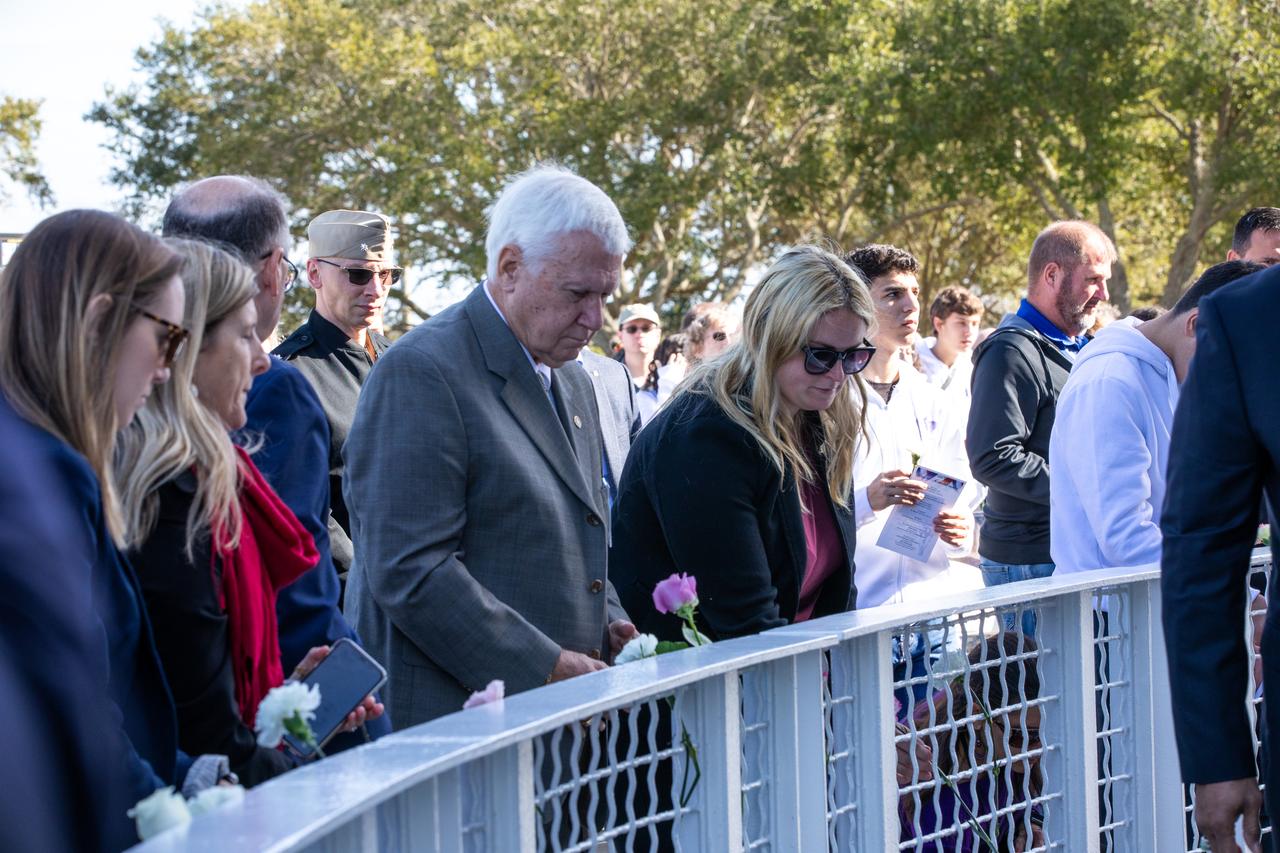 Attendees of NASA’s Day of Remembrance ceremony at the Space Mirror Memorial in the Kennedy Space Center Visitor Complex on Jan. 30, 2020 insert flowers into the fence in front of the wall. The crews of Apollo 1 and space shuttles Challenger and Columbia, as well as other fallen astronauts who lost their lives in the name of space exploration and discovery, were honored at the annual event.