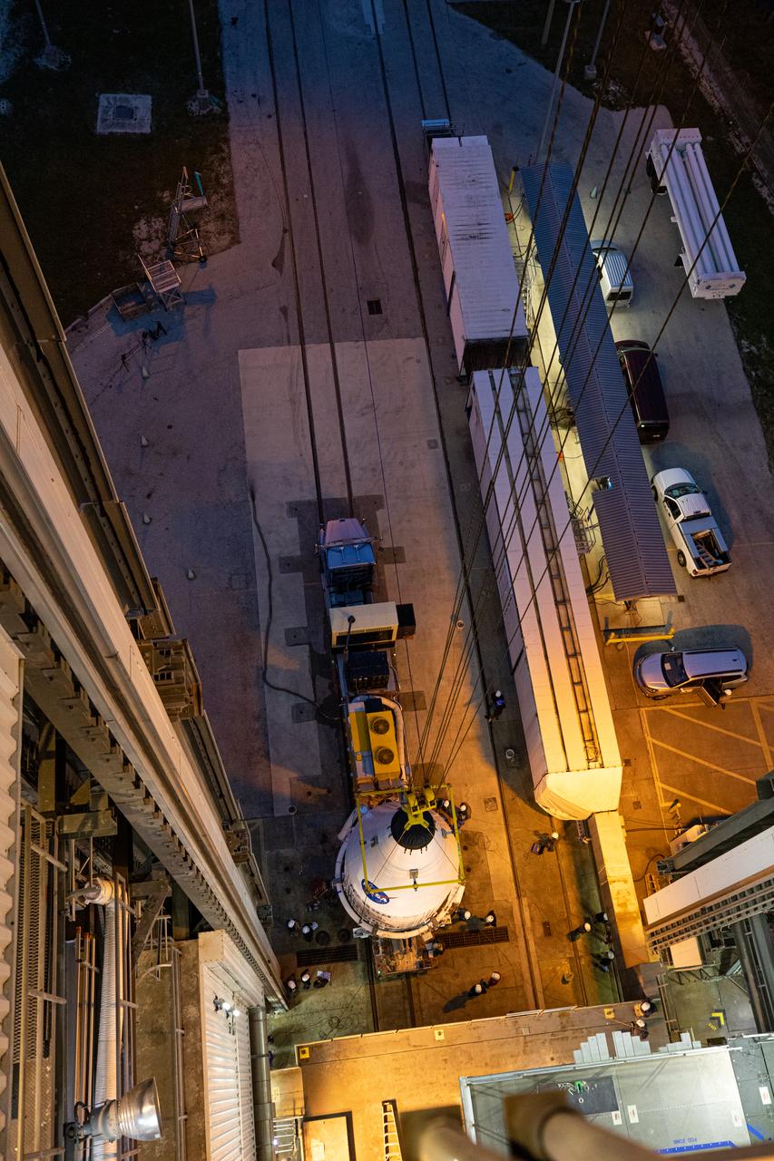 In this view from above, the United Launch Alliance Atlas V payload fairing, containing the Solar Orbiter spacecraft, is hoisted up by crane at the Vertical Integration Facility at Space Launch Complex 41 on Cape Canaveral Air Force Station in Florida on Jan. 31, 2020. The payload fairing will be mated to the Atlas V rocket. Solar Orbiter is an international cooperative mission between ESA (European Space Agency) and NASA. The mission aims to study the Sun, its outer atmosphere and solar wind. The spacecraft will provide the first images of the Sun’s poles. NASA’s Launch Services Program based at Kennedy is managing the launch. The spacecraft has been developed by Airbus Defence and Space. Solar Orbiter will launch in February 2020 aboard the Atlas V rocket.