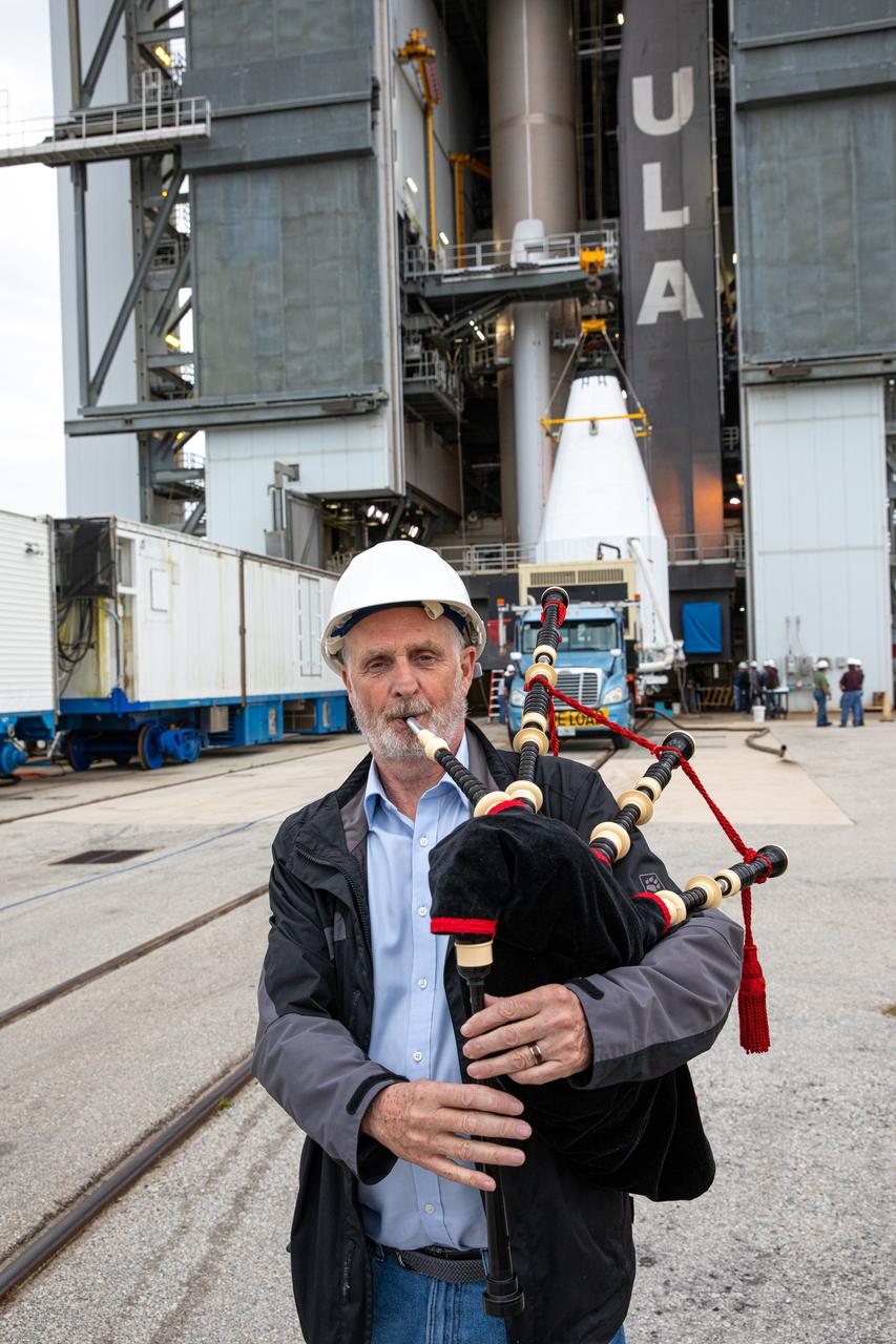 An Airbus Defence and Space worker plays the bagpipes at the Vertical Integration Facility at Space Launch Complex 41 on Cape Canaveral Air Force Station in Florida on Jan. 31, 2020. It is a tradition for the company to play the bagpipes during spacecraft mate to rocket. In the background, a crane lifts the United Launch Alliance payload fairing, containing the Solar Orbiter spacecraft, for mating to the company’s Atlas V rocket. Solar Orbiter is an international cooperative mission between ESA (European Space Agency) and NASA. The mission aims to study the Sun, its outer atmosphere and solar wind. The spacecraft will provide the first images of the Sun’s poles. NASA’s Launch Services Program based at Kennedy is managing the launch. The spacecraft has been developed by Airbus Defence and Space. Solar Orbiter will launch in February 2020 aboard the Atlas V rocket.