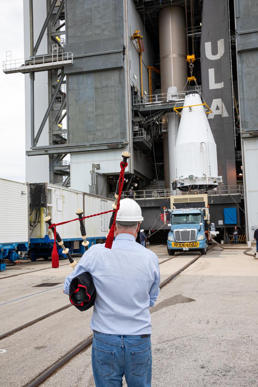 An Airbus Defence and Space worker plays the bagpipes at the Vertical Integration Facility at Space Launch Complex 41 on Cape Canaveral Air Force Station in Florida on Jan. 31, 2020. It is a tradition for the company to play the bagpipes during spacecraft mate to rocket. In the background, a crane lifts the United Launch Alliance payload fairing, containing the Solar Orbiter spacecraft, for mating to the company’s Atlas V rocket. Solar Orbiter is an international cooperative mission between ESA (European Space Agency) and NASA. The mission aims to study the Sun, its outer atmosphere and solar wind. The spacecraft will provide the first images of the Sun’s poles. NASA’s Launch Services Program based at Kennedy is managing the launch. The spacecraft has been developed by Airbus Defence and Space. Solar Orbiter will launch in February 2020 aboard the Atlas V rocket.