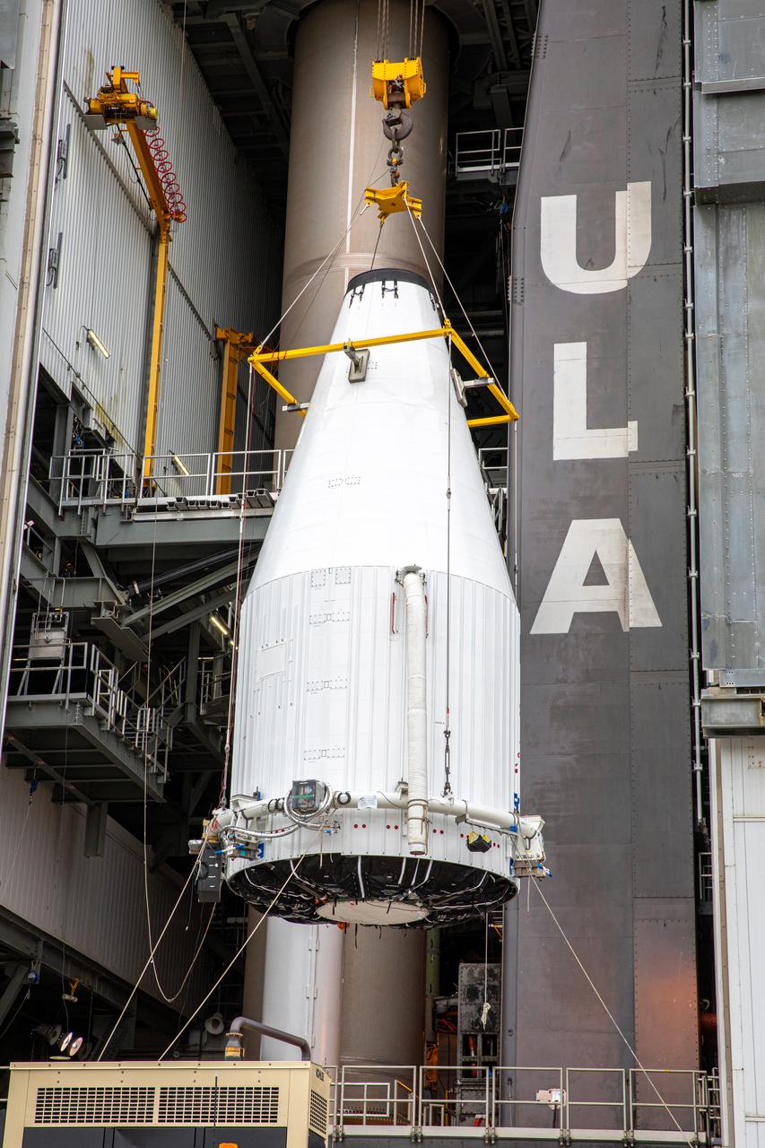 The United Launch Alliance Atlas V payload fairing, containing the Solar Orbiter spacecraft, is hoisted up by crane at the Vertical Integration Facility at Space Launch Complex 41 on Cape Canaveral Air Force Station in Florida on Jan. 31, 2020. The payload fairing will be mated to the Atlas V rocket. Solar Orbiter is an international cooperative mission between ESA (European Space Agency) and NASA. The mission aims to study the Sun, its outer atmosphere and solar wind. The spacecraft will provide the first images of the Sun’s poles. NASA’s Launch Services Program based at Kennedy is managing the launch. The spacecraft has been developed by Airbus Defence and Space. Solar Orbiter will launch in February 2020 aboard the Atlas V rocket.