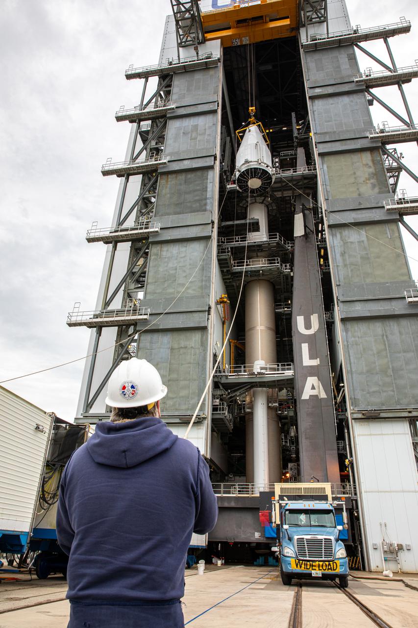 The United Launch Alliance Atlas V payload fairing, containing the Solar Orbiter spacecraft, is hoisted up by crane at the Vertical Integration Facility at Space Launch Complex 41 on Cape Canaveral Air Force Station in Florida on Jan. 31, 2020. The payload fairing will be mated to the Atlas V rocket. Solar Orbiter is an international cooperative mission between ESA (European Space Agency) and NASA. The mission aims to study the Sun, its outer atmosphere and solar wind. The spacecraft will provide the first images of the Sun’s poles. NASA’s Launch Services Program based at Kennedy is managing the launch. The spacecraft has been developed by Airbus Defence and Space. Solar Orbiter will launch in February 2020 aboard the Atlas V rocket.