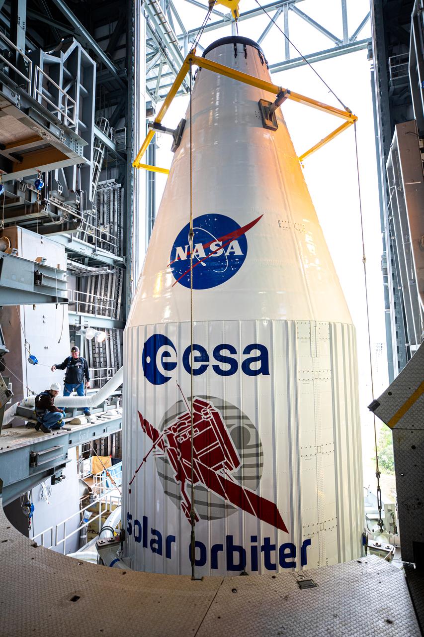 The United Launch Alliance Atlas V payload fairing, containing the Solar Orbiter spacecraft, is lowered onto the company’s Atlas V rocket inside the Vertical Integration Facility at Space Launch Complex 41 on Cape Canaveral Air Force Station in Florida on Jan. 31, 2020. The payload fairing will be secured to the rocket. Solar Orbiter is an international cooperative mission between ESA (European Space Agency) and NASA. The mission aims to study the Sun, its outer atmosphere and solar wind. The spacecraft will provide the first images of the Sun’s poles. NASA’s Launch Services Program based at Kennedy is managing the launch. The spacecraft has been developed by Airbus Defence and Space. Solar Orbiter will launch in February 2020 aboard the Atlas V rocket.