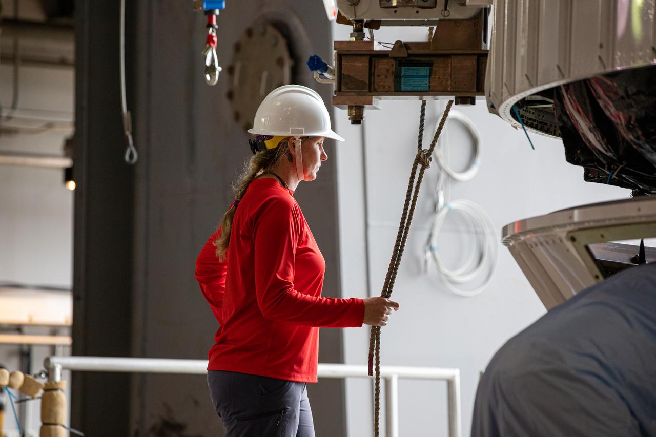 High up in the Vertical Integration Facility at Space Launch Complex 41 on Cape Canaveral Air Force Station in Florida, a worker watches as the United Launch Alliance Atlas V payload fairing, containing the Solar Orbiter spacecraft, is lowered onto the Atlas V rocket on Jan. 31, 2020. Solar Orbiter is an international cooperative mission between ESA (European Space Agency) and NASA. The mission aims to study the Sun, its outer atmosphere and solar wind. The spacecraft will provide the first images of the Sun’s poles. NASA’s Launch Services Program based at Kennedy is managing the launch. The spacecraft has been developed by Airbus Defence and Space. Solar Orbiter will launch in February 2020 aboard the Atlas V rocket.