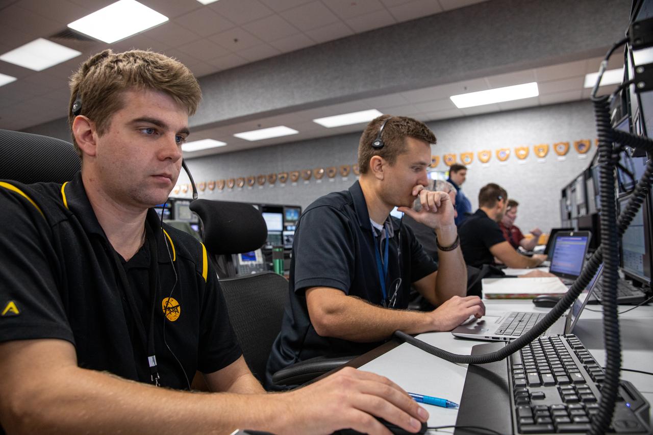 Michael Dennison, left, and James Ross, ground cooling system engineers at NASA’s Kennedy Space Center in Florida, participate in an Artemis I launch countdown training simulation on Feb. 3, 2020. Under the leadership of Launch Director Charlie Blackwell-Thompson, a team of nearly 100 engineers from Orion, Space Launch System (SLS) and NASA’s Exploration Ground Systems came together in the Launch Control Center’s Firing Room 1 to work through a series of simulated challenges, as well as a final countdown procedure. During these exercises, different issues were introduced to familiarize the team with launch day operations, while providing them with an opportunity to practice how they would handle those issues in real-time. Artemis I will be the first integrated test flight of the Orion spacecraft and SLS rocket – the system that will ultimately land the first woman and the next man on the Moon. 