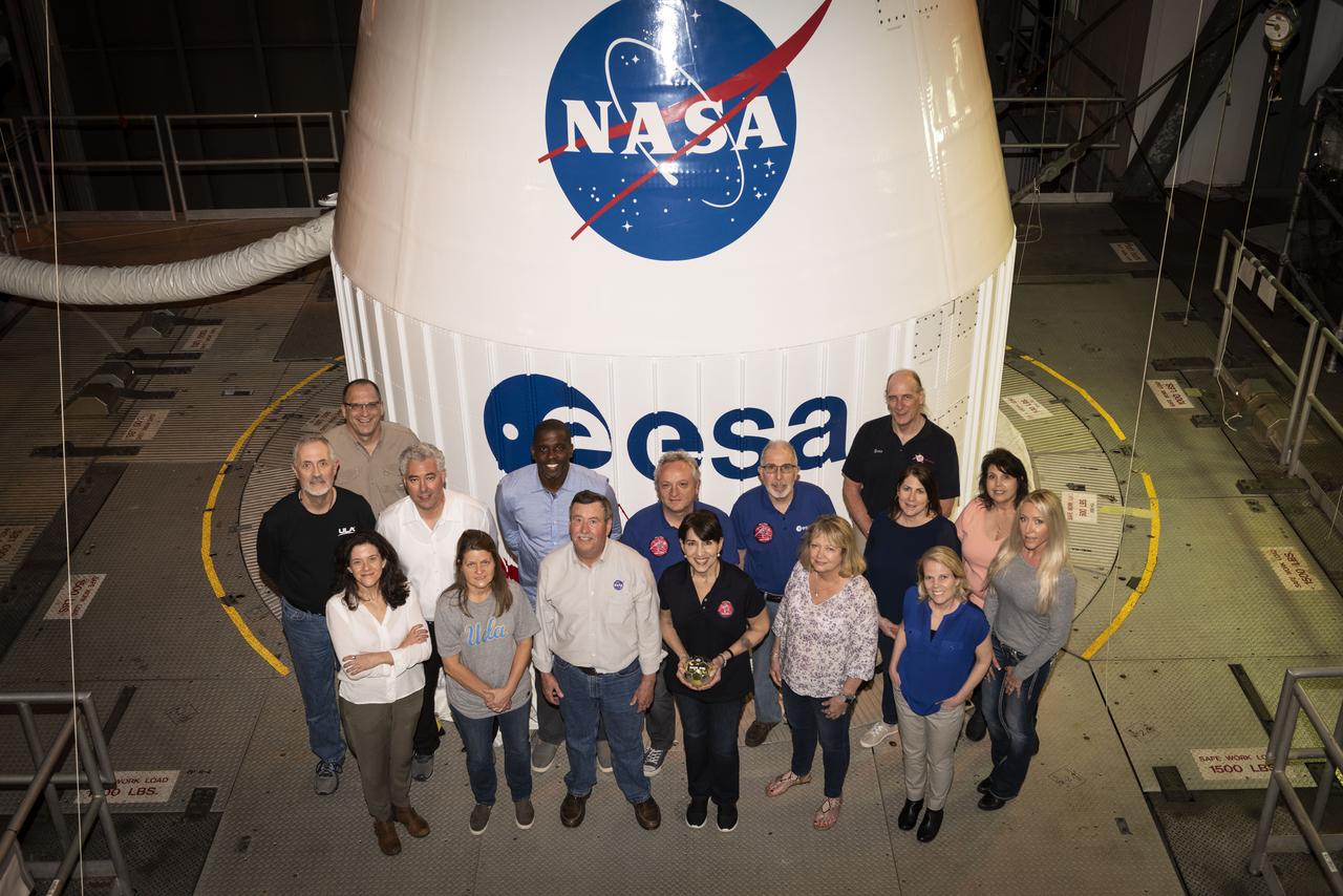 Members of the Goddard Space Flight Center Solar Orbiter Collaboration Project Office, along with Launch Services Program’s (LSP) Jim Behling (back left), launch site integration manager, pose in front of the Solar Orbiter spacecraft inside the Vertical Integration Facility at Cape Canaveral Air Force Station’s Space Launch Complex 41 in Florida. Solar Orbiter is an international cooperative mission between ESA (European Space Agency) and NASA. The spacecraft will provide the first images of the Sun’s poles. NASA’s LSP, based at Kennedy Space Center, is managing the launch.