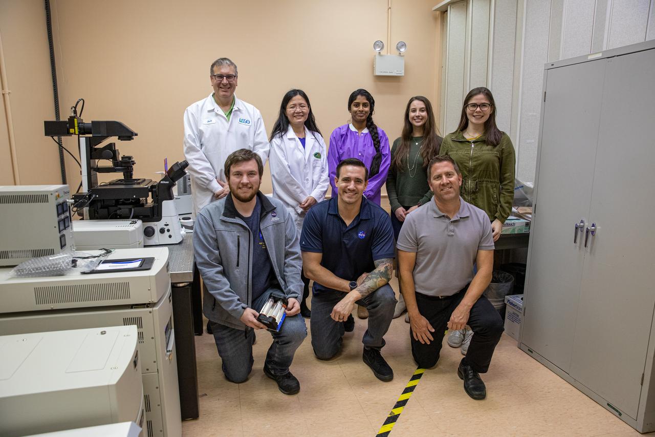 Researchers are in the Microgravity Simulation Support Facility (MSSF) inside the Neil Armstrong Operations and Checkout building at NASA’s Kennedy Space Center in Florida on Feb. 11, 2020. In front, from left, are Jonathan Gleeson, aerospace engineer on the LASSO contract; Jason Fischer, a research and development scientist on the LASSO contract; and Ralph Nacca, aerospace flight systems. In back, from left, are Jeffrey Richards, a payload research and science coordinator on the LASSO contract; Dr. Ye Zhang, a project scientist; Dr. Srujana Neelam, a NASA post-doctoral fellow; Jessica Hellein, NASA intern; and Emily Keith, NASA intern. The facility was developed to provide ground simulation capability to the U.S. research community in order to supplement the limited opportunities to access the International Space Station and other platforms for microgravity research. The MSSF is designed to support biological research on microorganisms, cells, tissues, small plants and small animals. The simulator provides NASA with an alternative platform for microgravity research and creates the opportunity to conduct experiments on the space station in parallel with conditions of simulated microgravity on the ground.